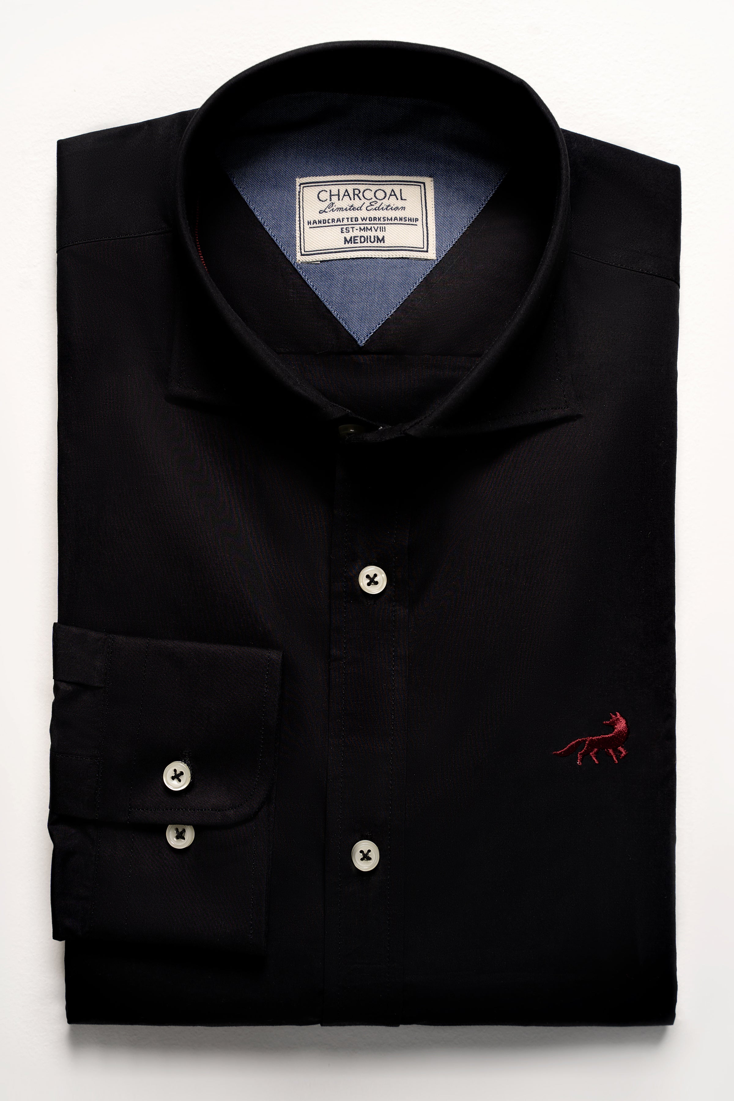Black button-up shirt with chest logo, button placket, and pocket detail