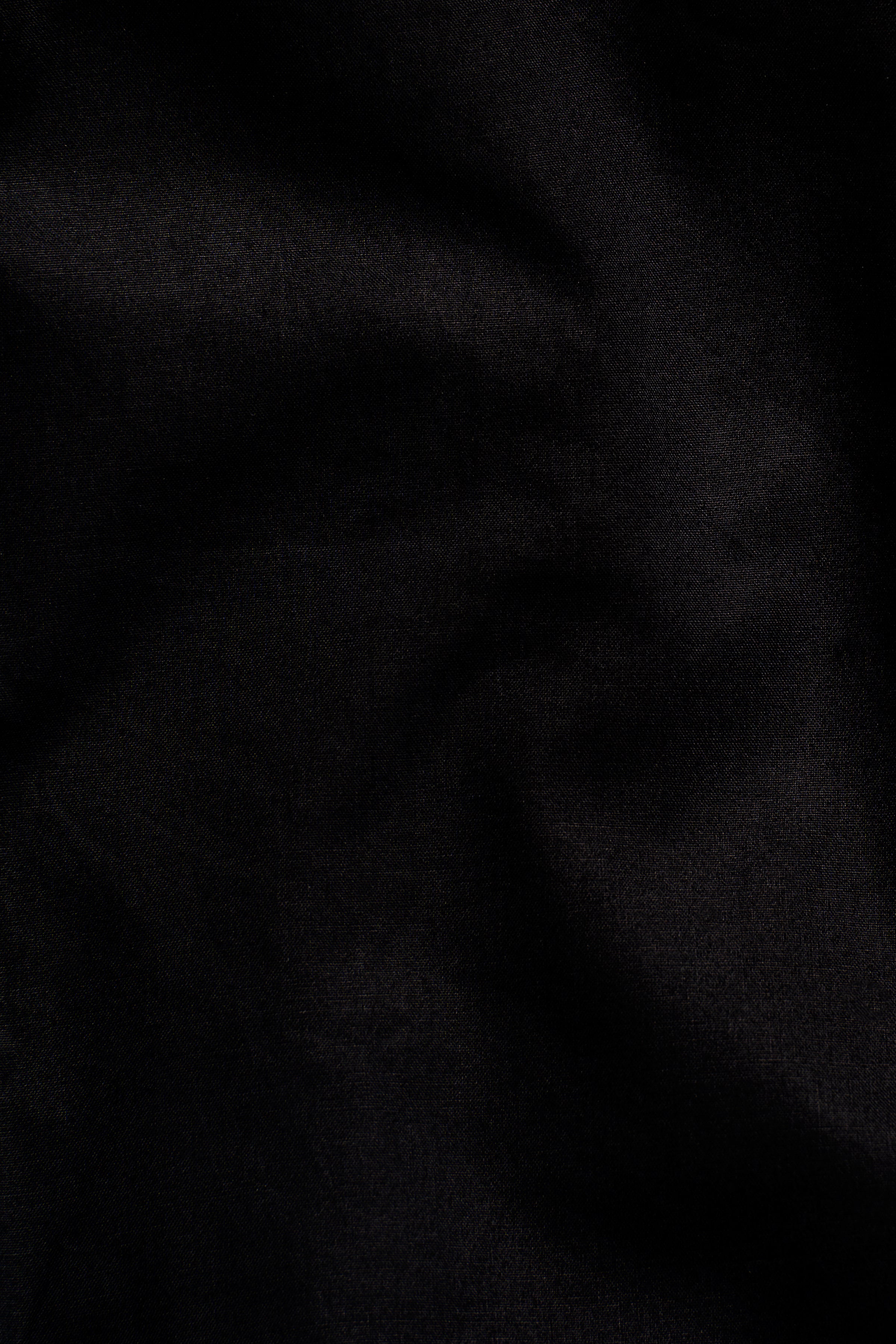 Black shirt fabric close-up with subtle weave texture