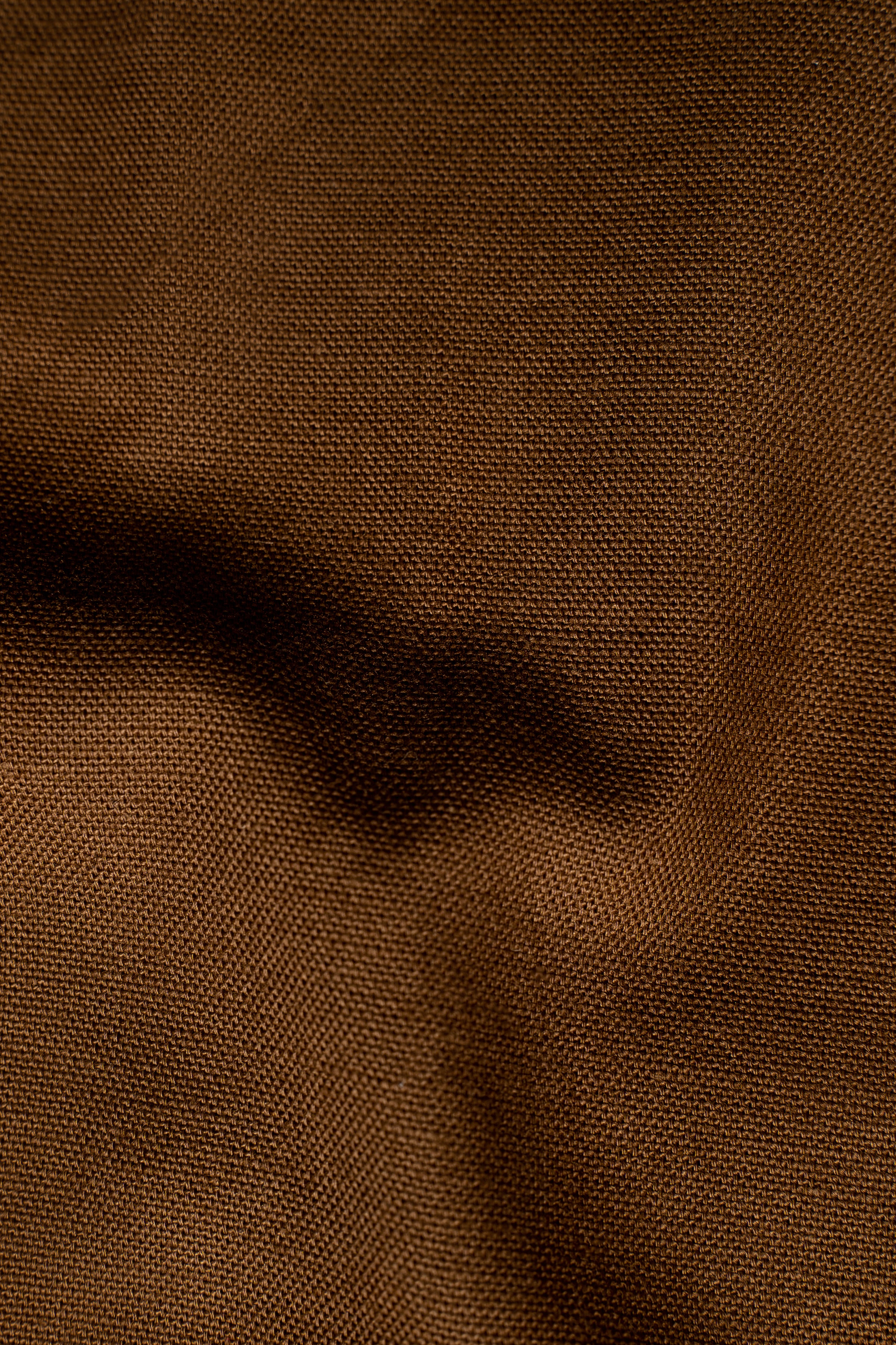 Brown woven dress shirt fabric texture close-up