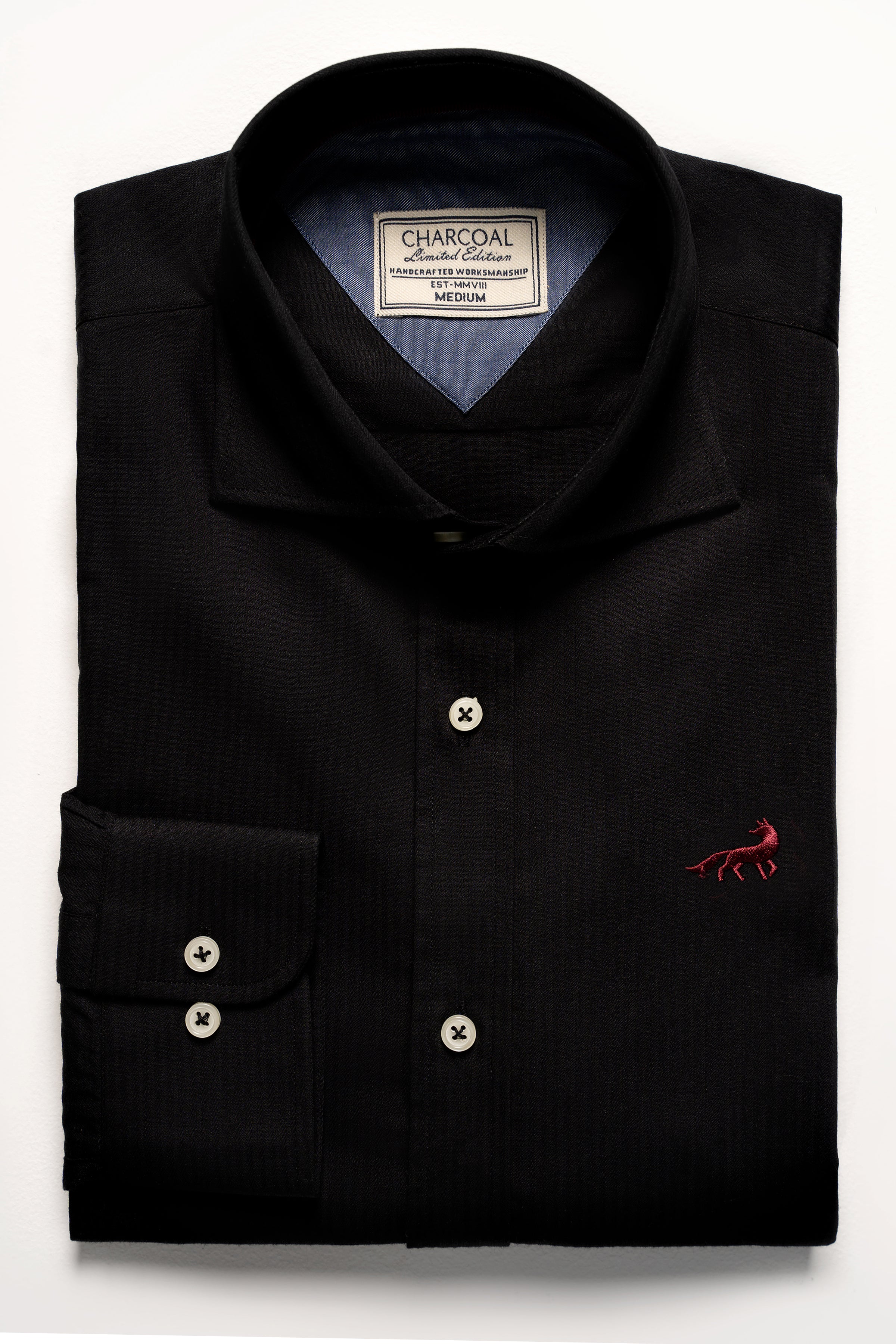 Black button-up shirt with button placket, stand collar, and small chest logo