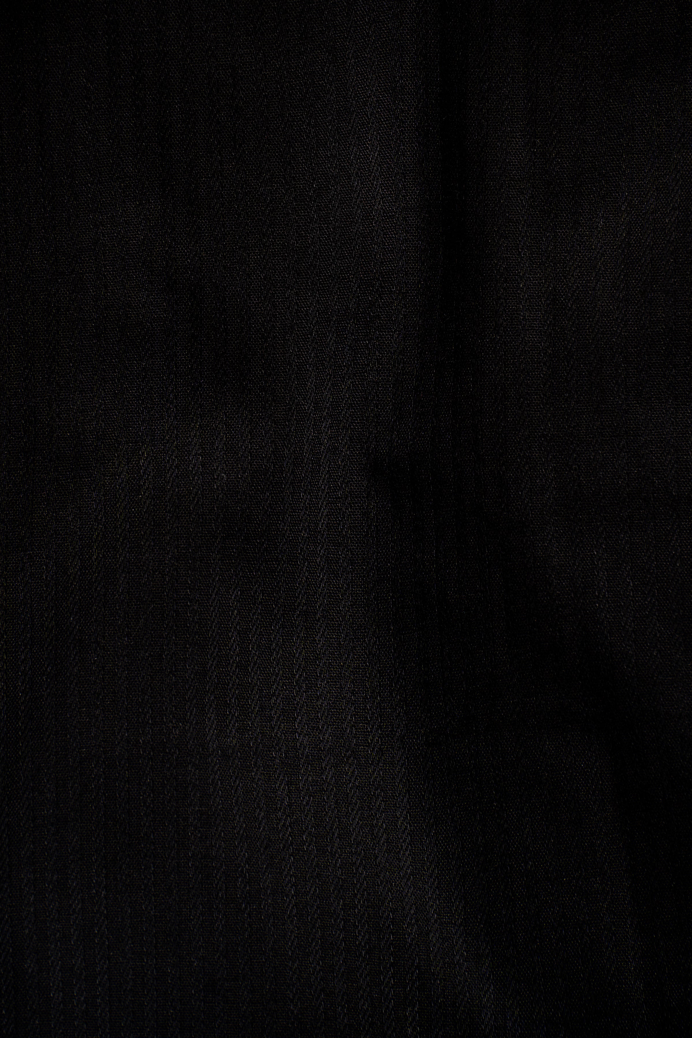 Black shirt fabric close-up with fine textured weave