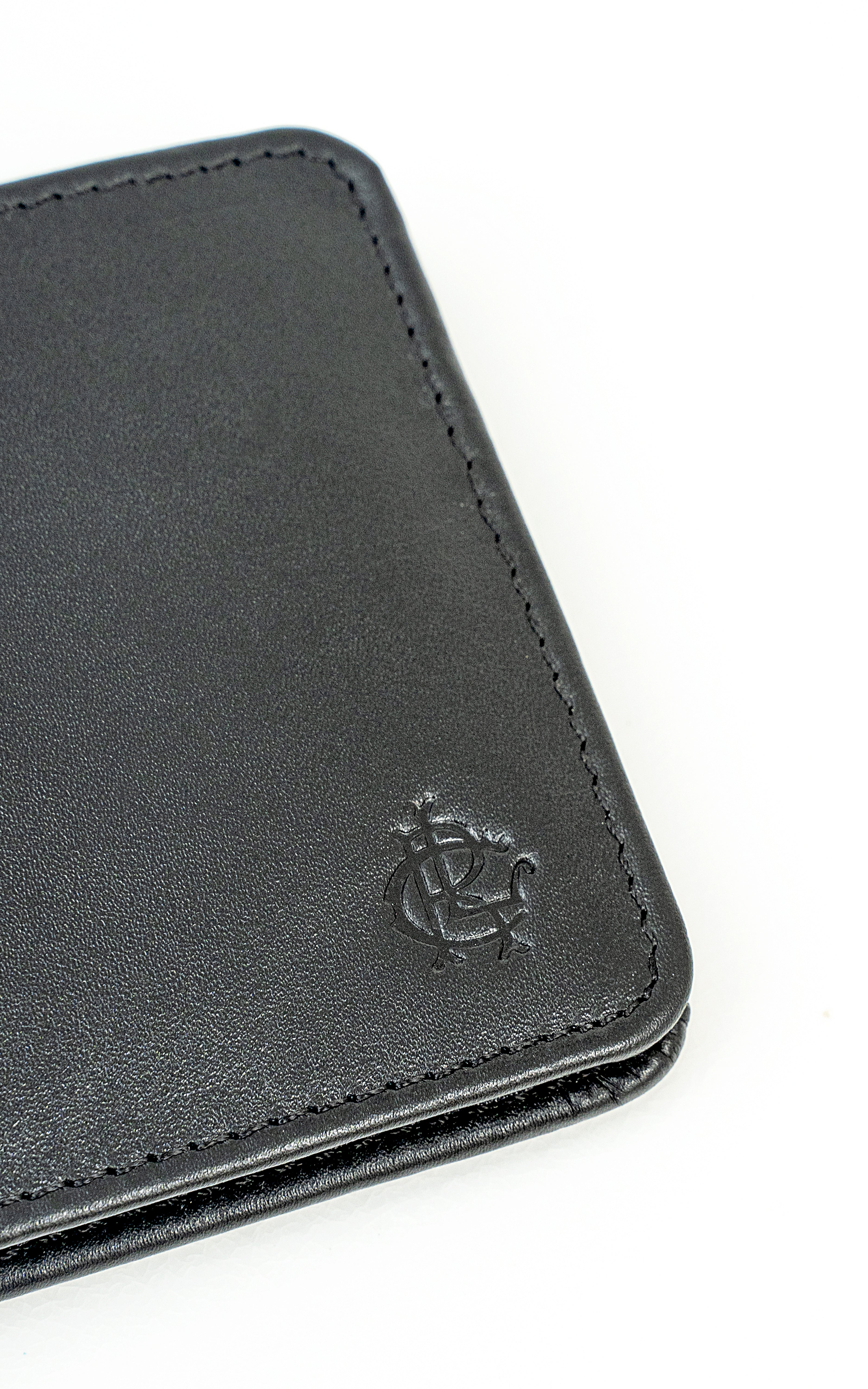 Black leather wallet corner with contrast stitching and embossed logo