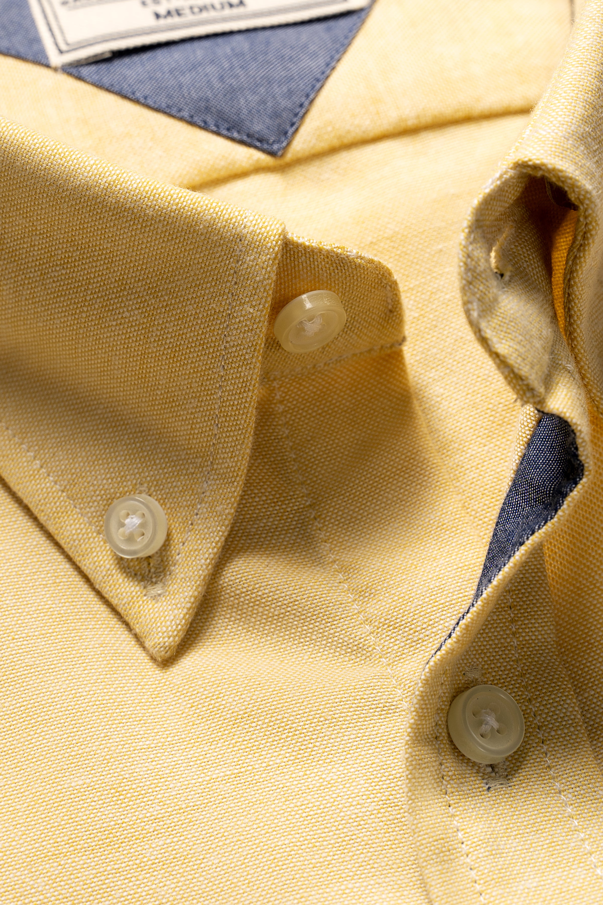 Lime yellow shirt collar and button placket close-up