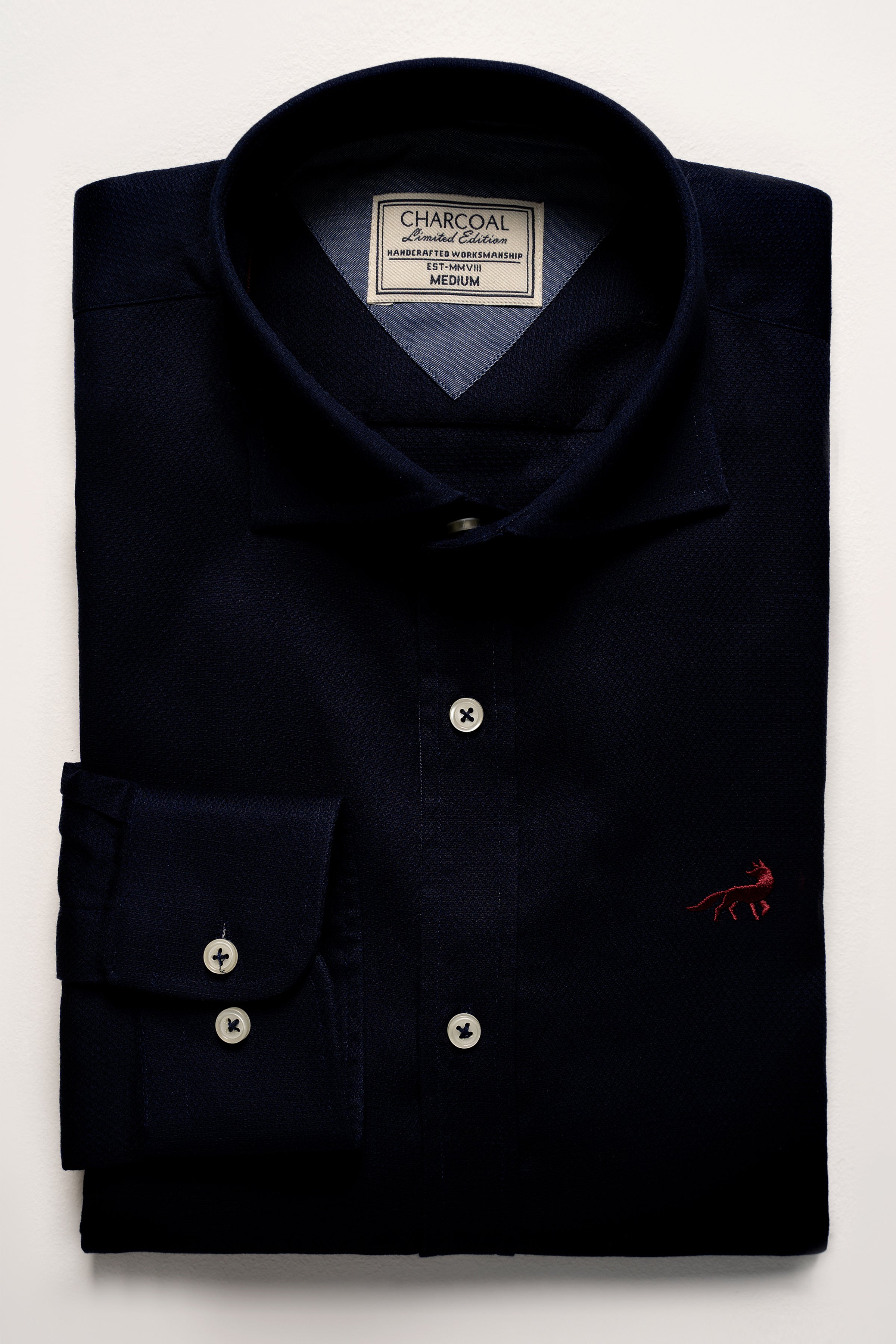 Navy blue limited edition dress shirt with button placket and chest logo