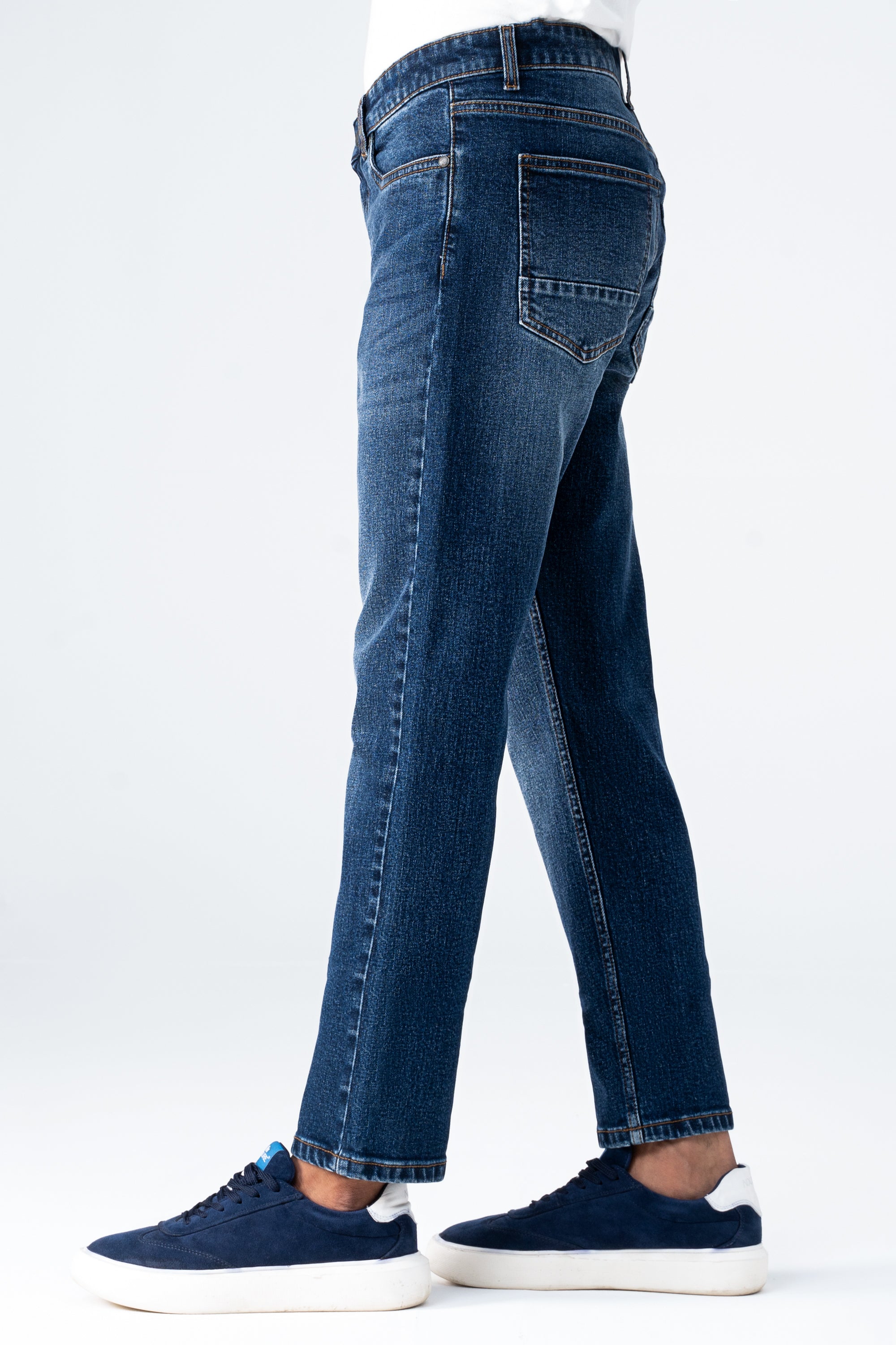 Straight-leg dark blue denim jeans side view with back yoke and patch pockets