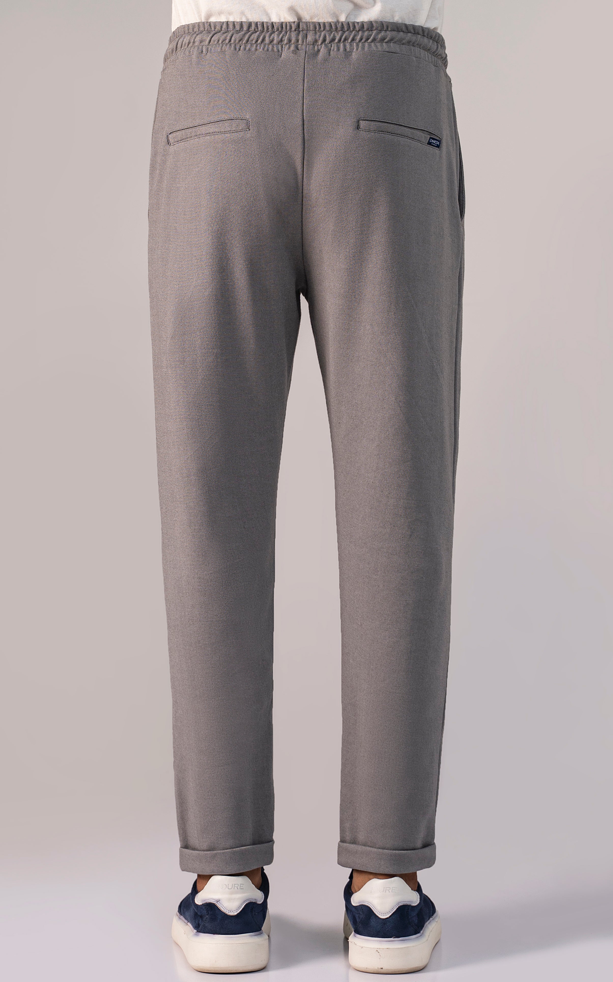 Grey melange trouser, two back pockets, elastic waistband and tapered ankle