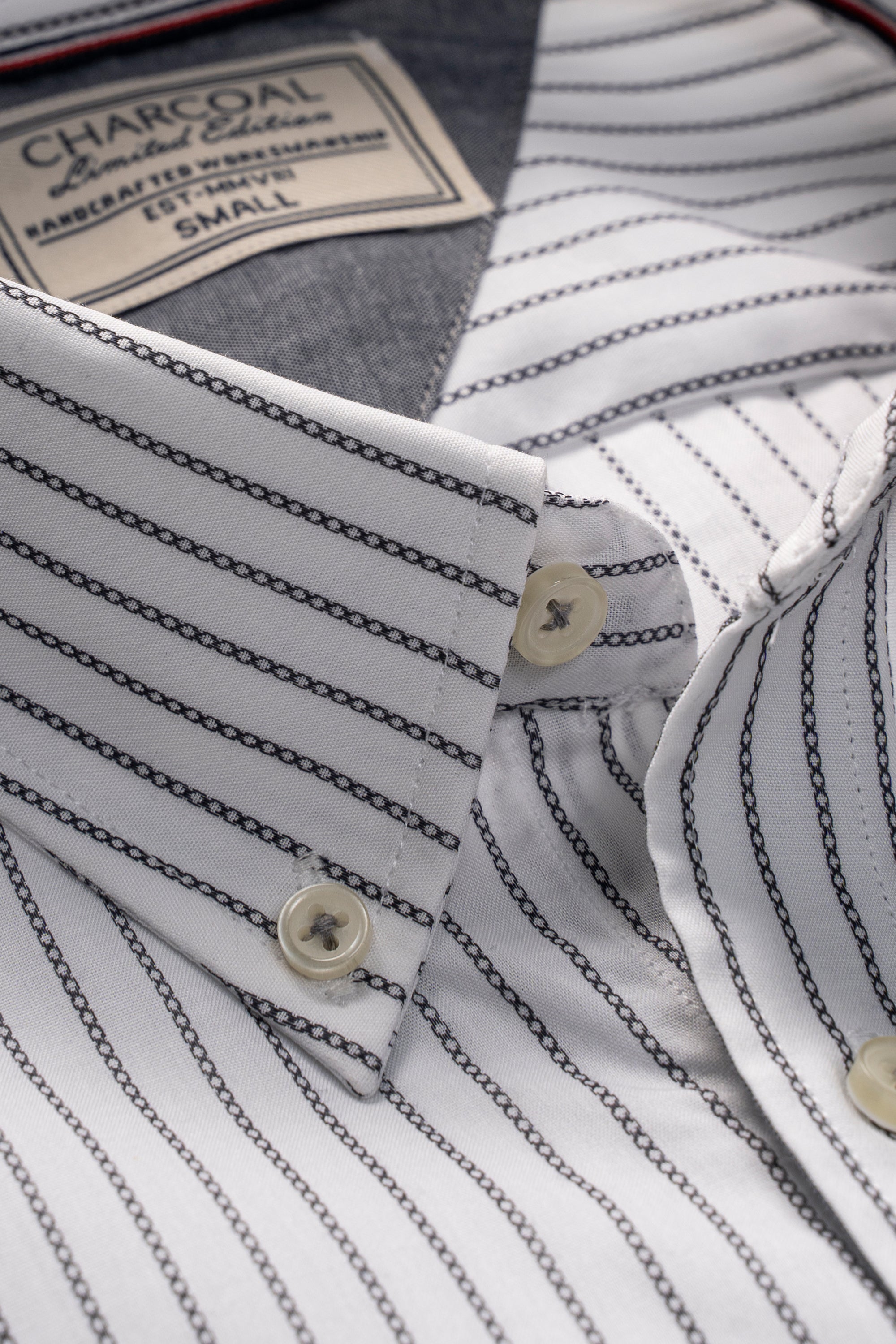 Striped dress shirt close-up: buttoned front placket and gold-tone buttons