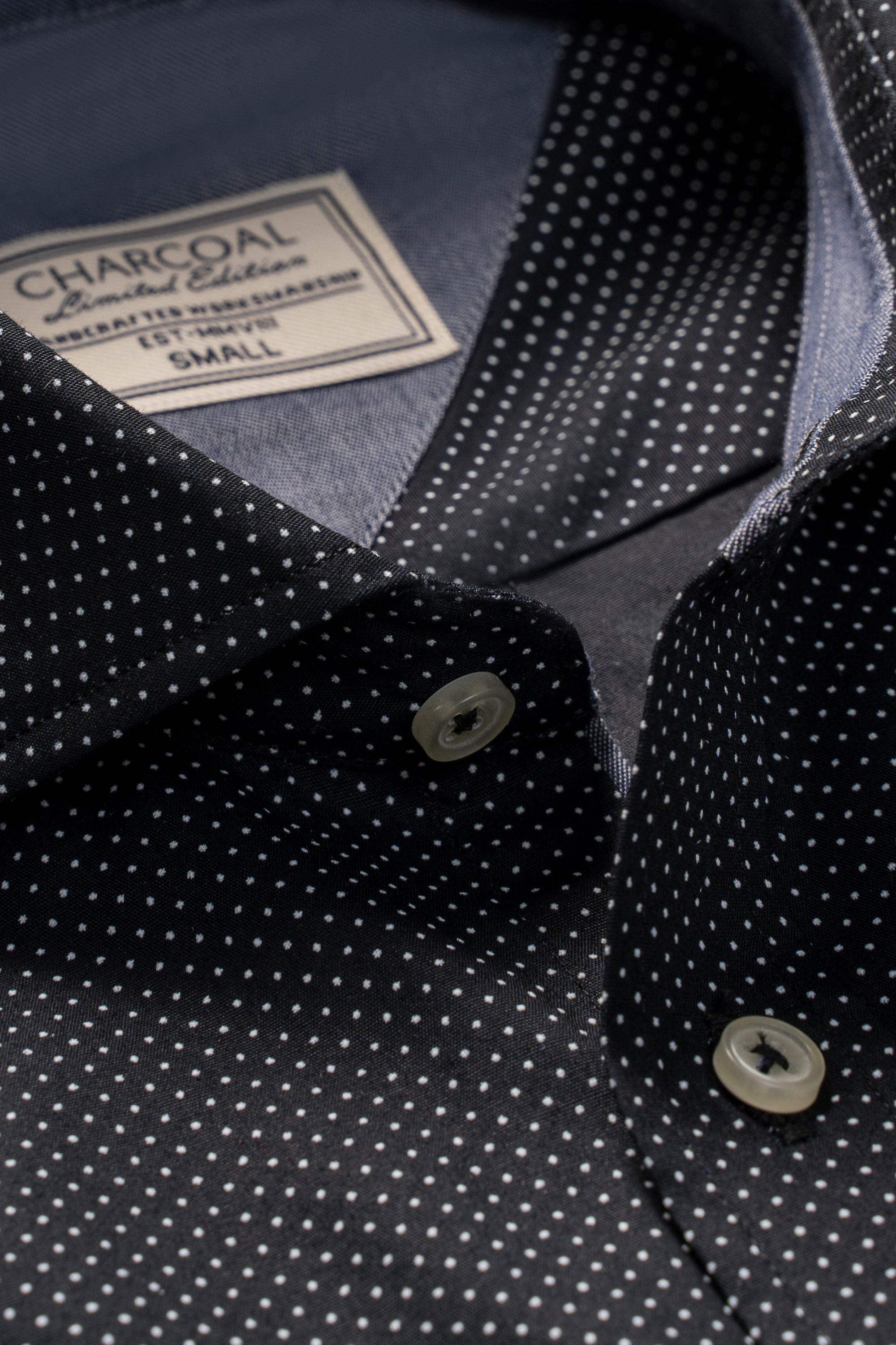 Limited edition shirt collar close-up with white dot print and front button placket