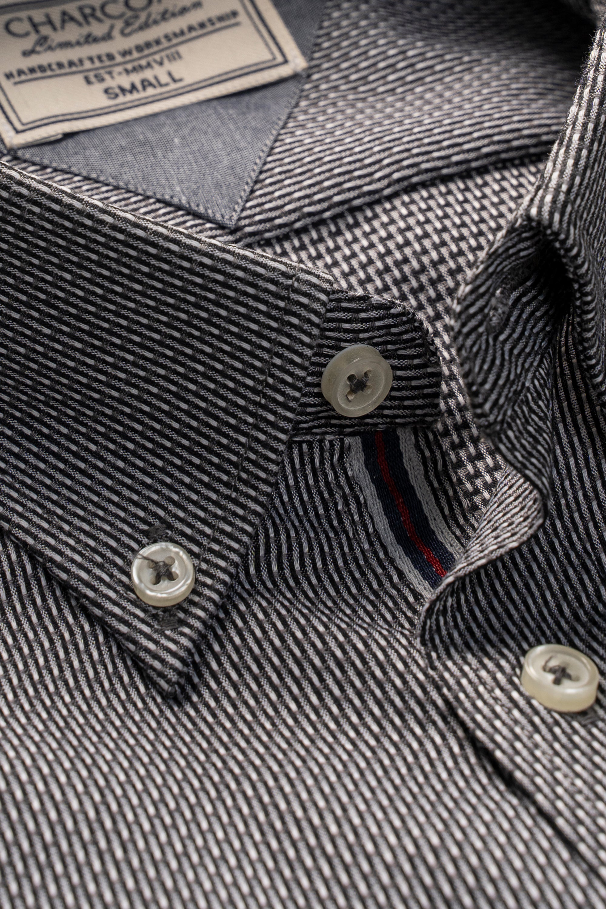 Charcoal-and-grey self-textured dress shirt close-up, button placket and collar