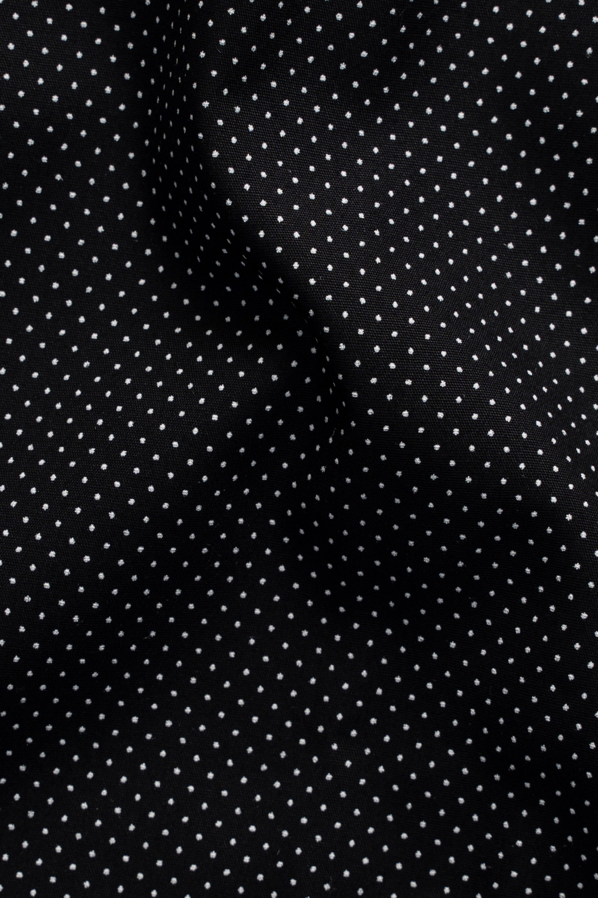 Limited edition black shirt fabric detail with repeating small white dots