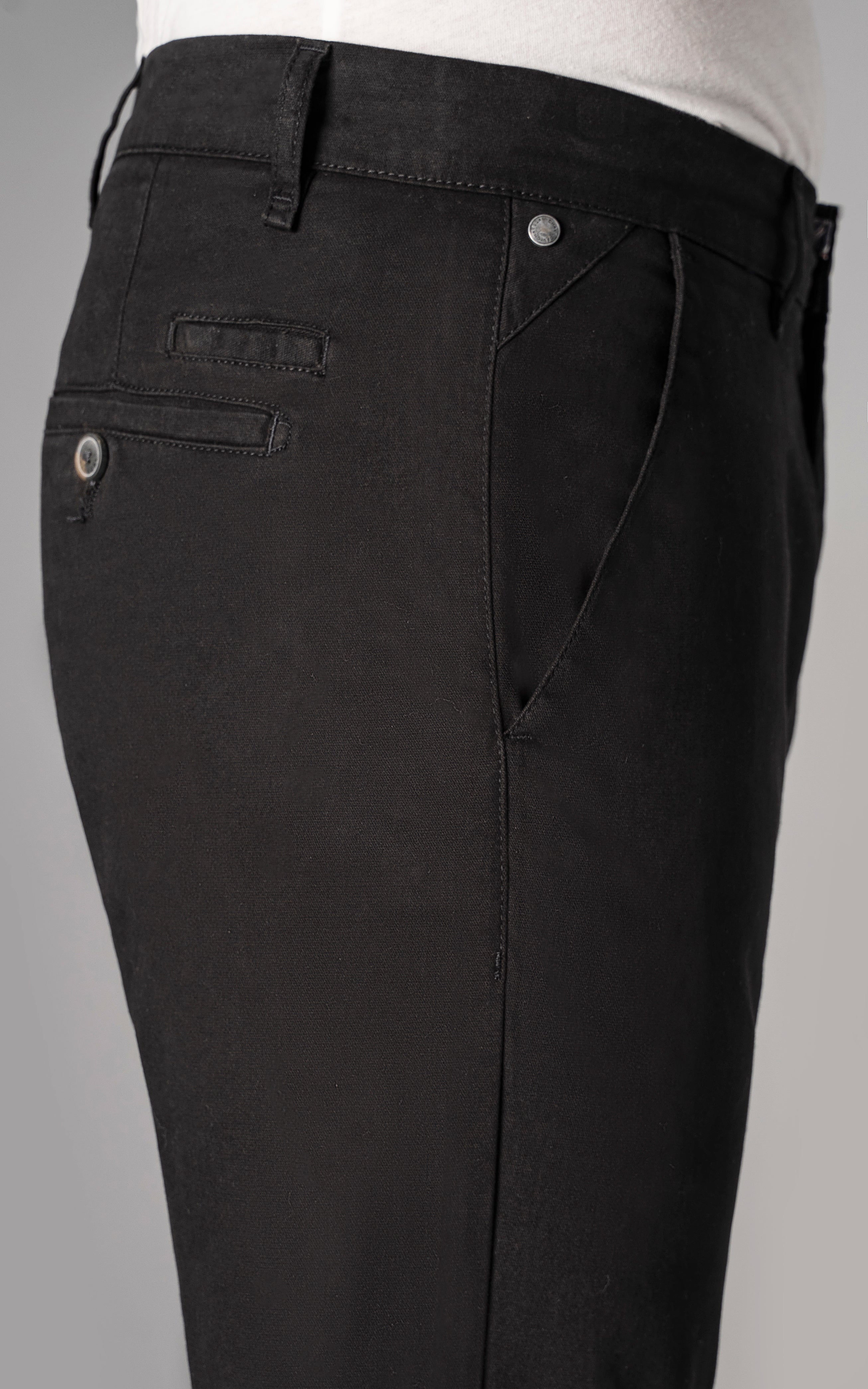 Black casual pants close-up: cross pocket with button, belt loops