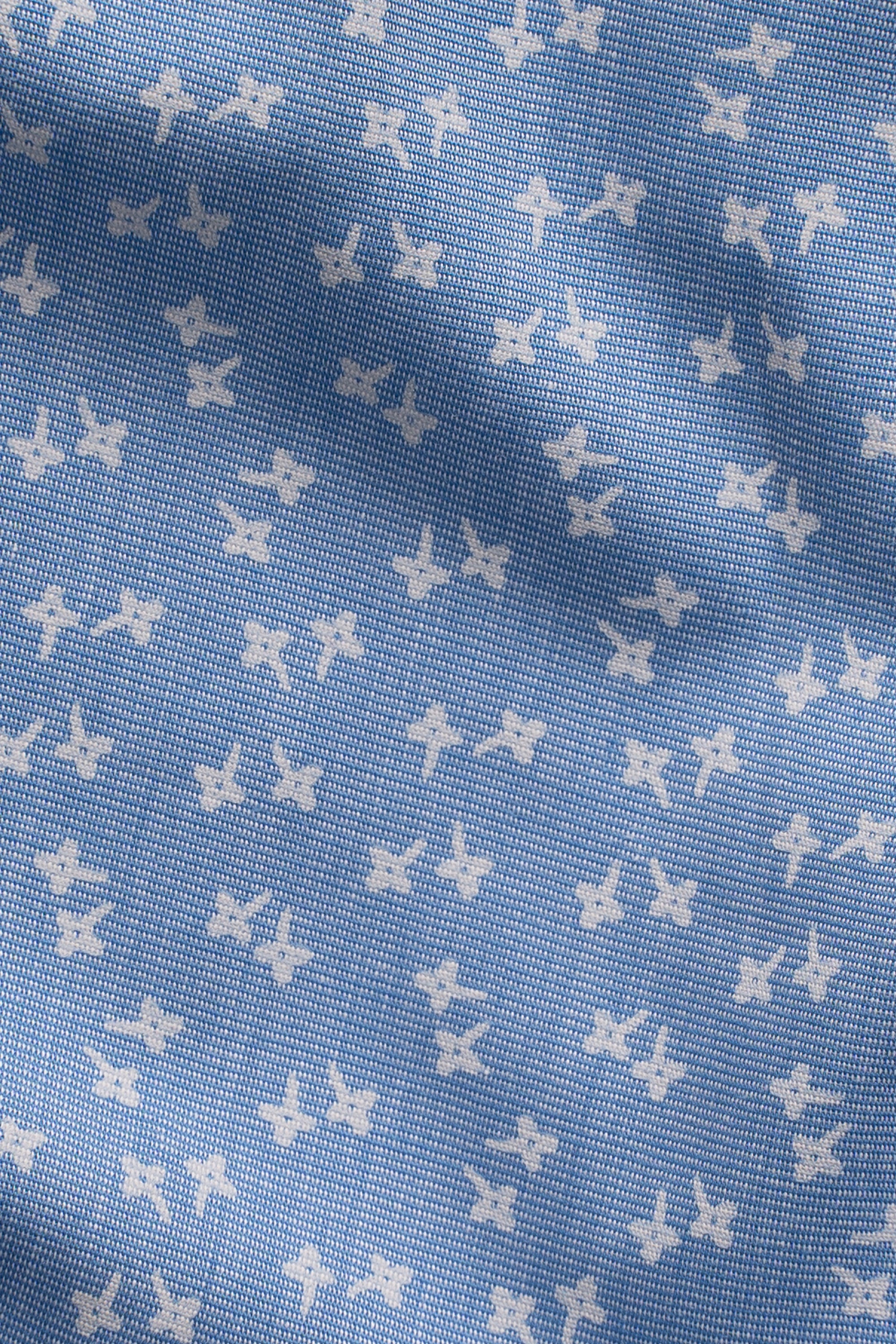 Sky blue shirt fabric with small star-print pattern texture
