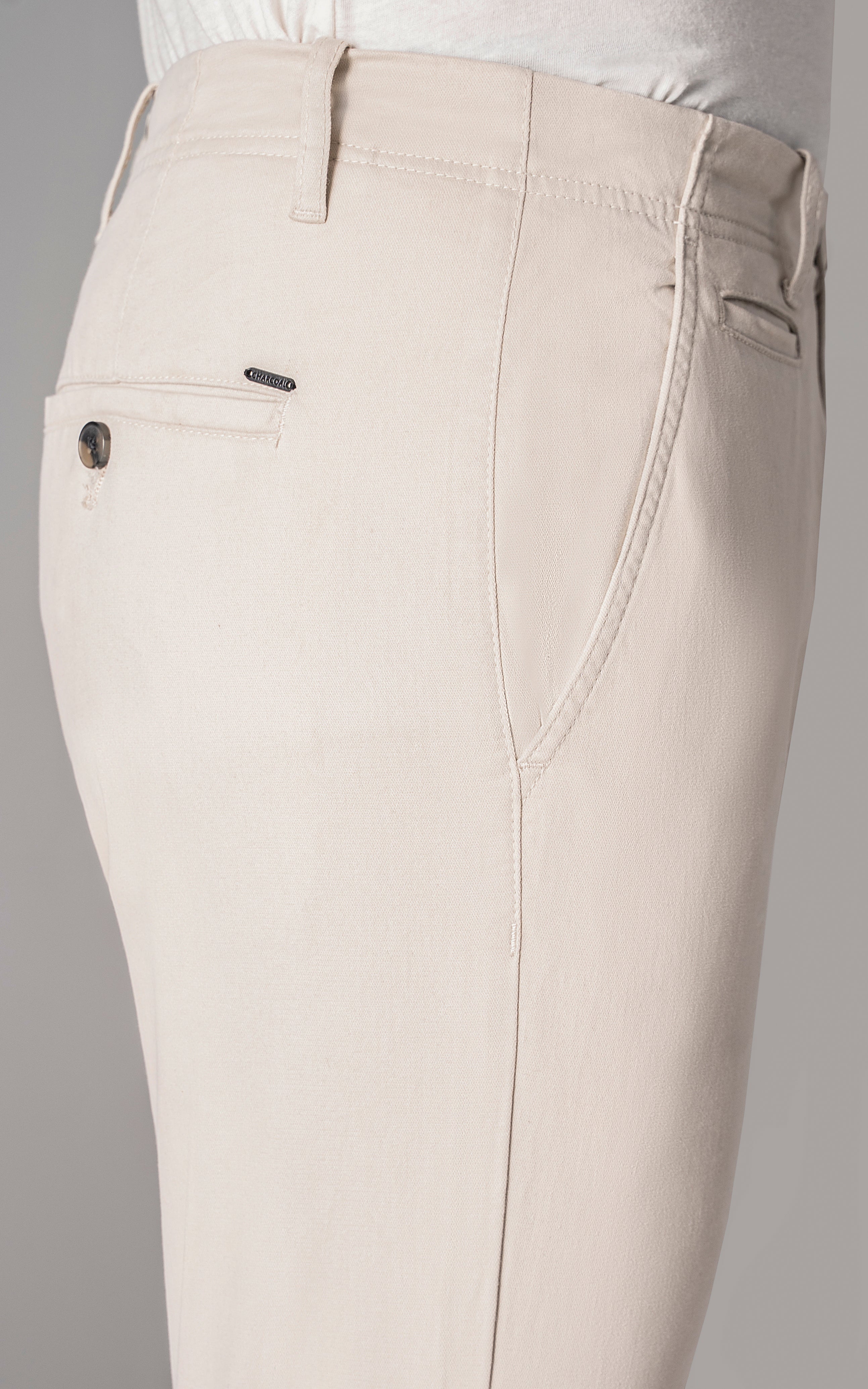 Ecru jeans-style pants close-up of front pockets and waistband