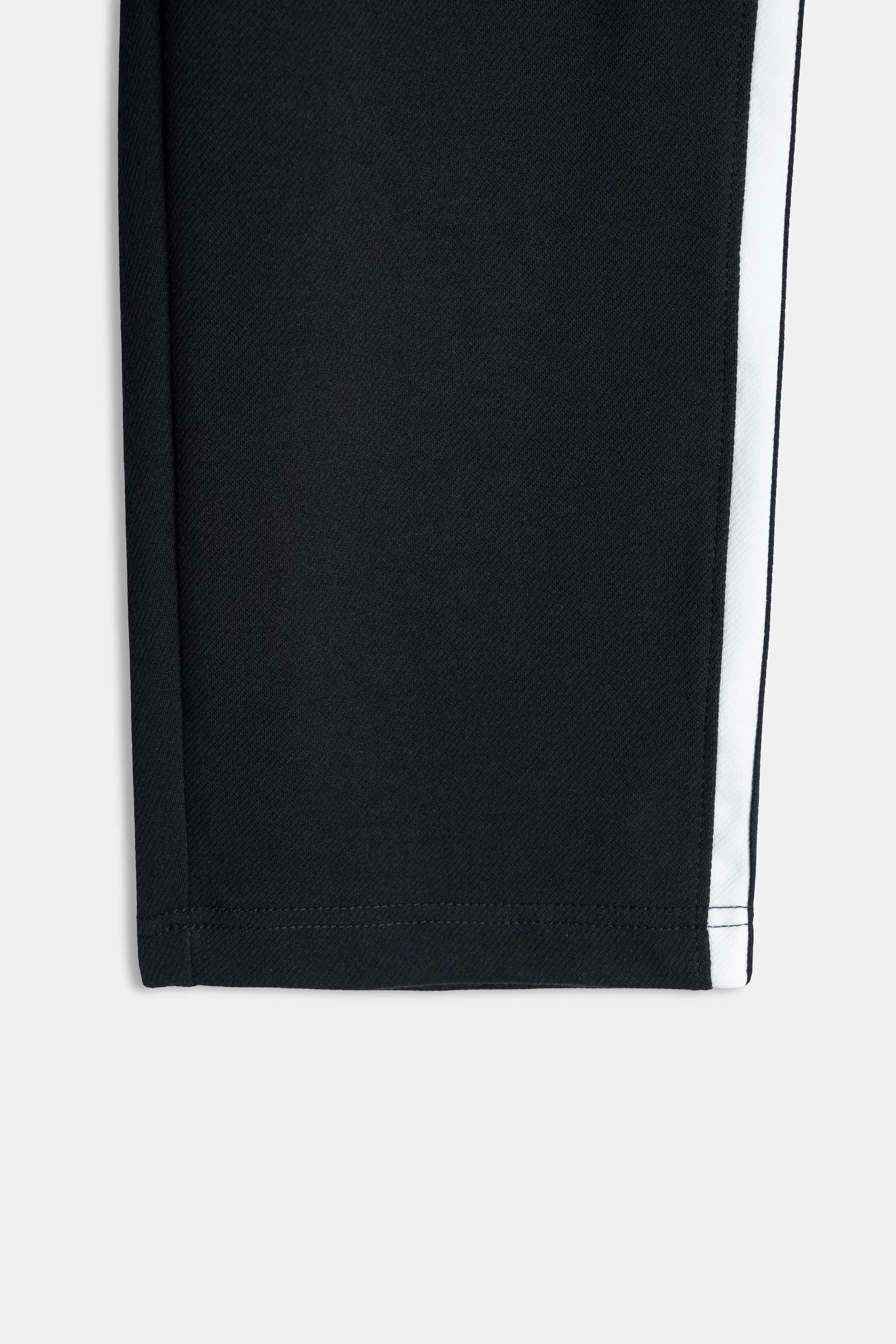 Black trouser hem with contrast side stripe seam