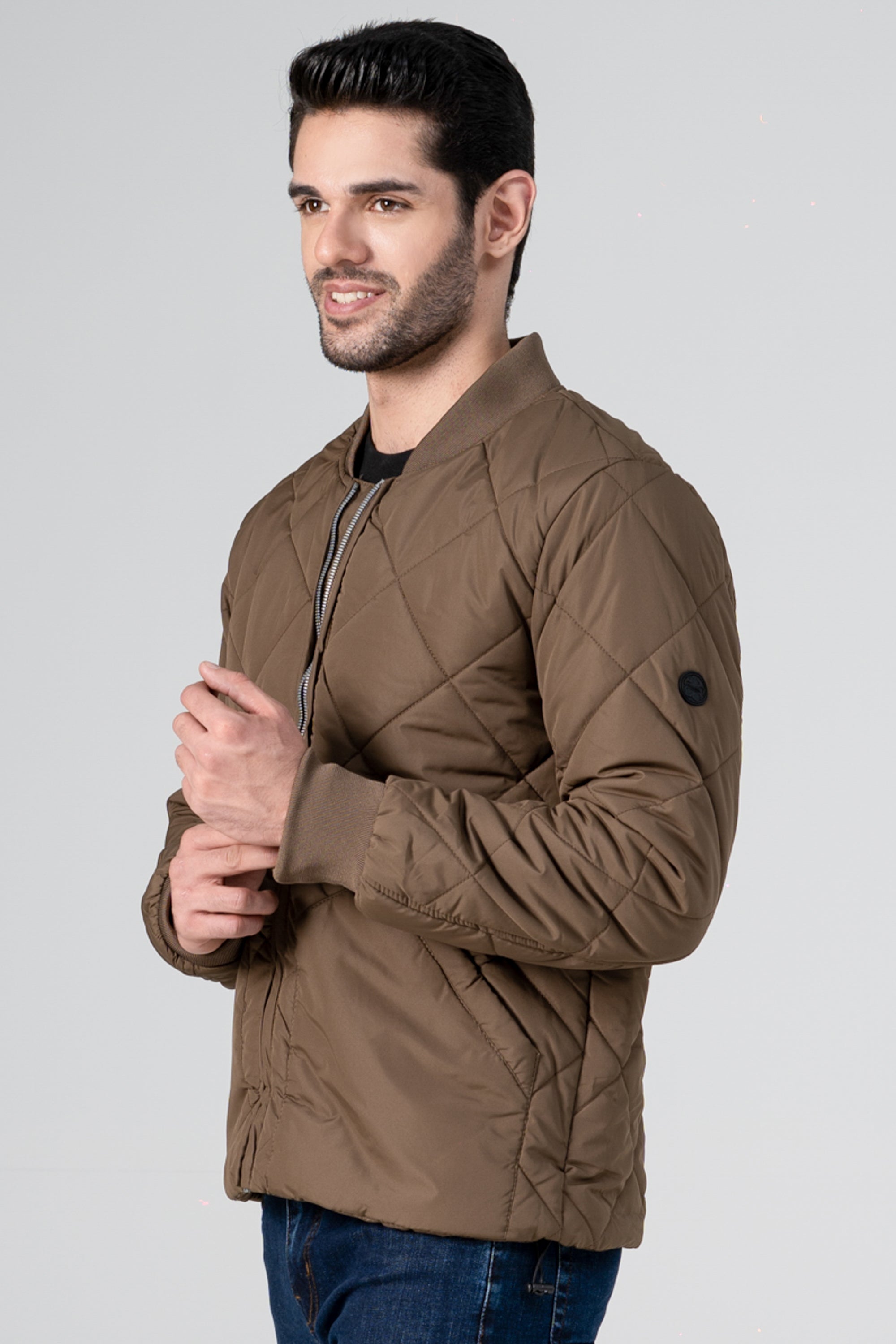 Quilted dark khaki bomber jacket with zip front and ribbed cuffs