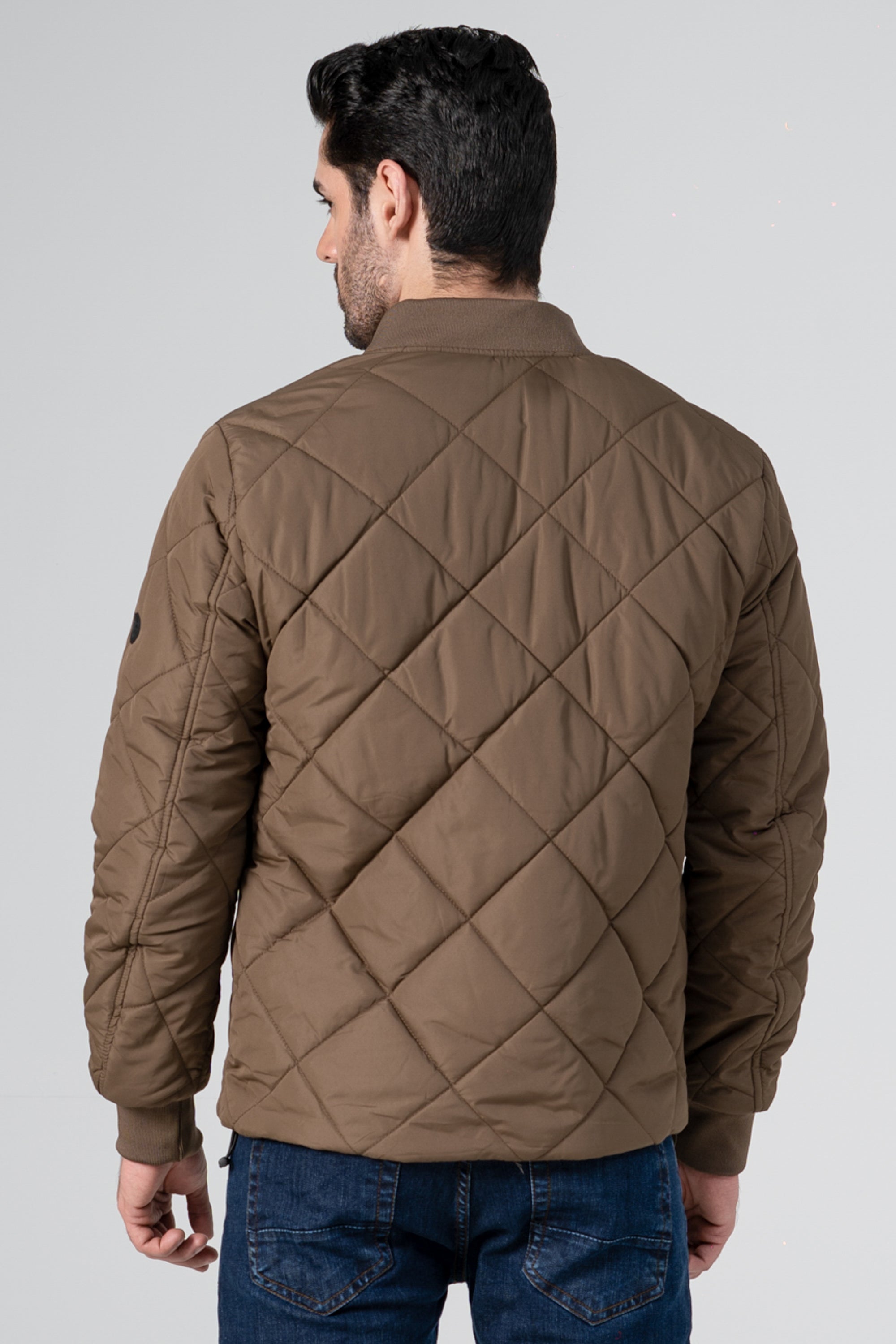 Quilted dark khaki bomber jacket back with diamond stitching and ribbed hem