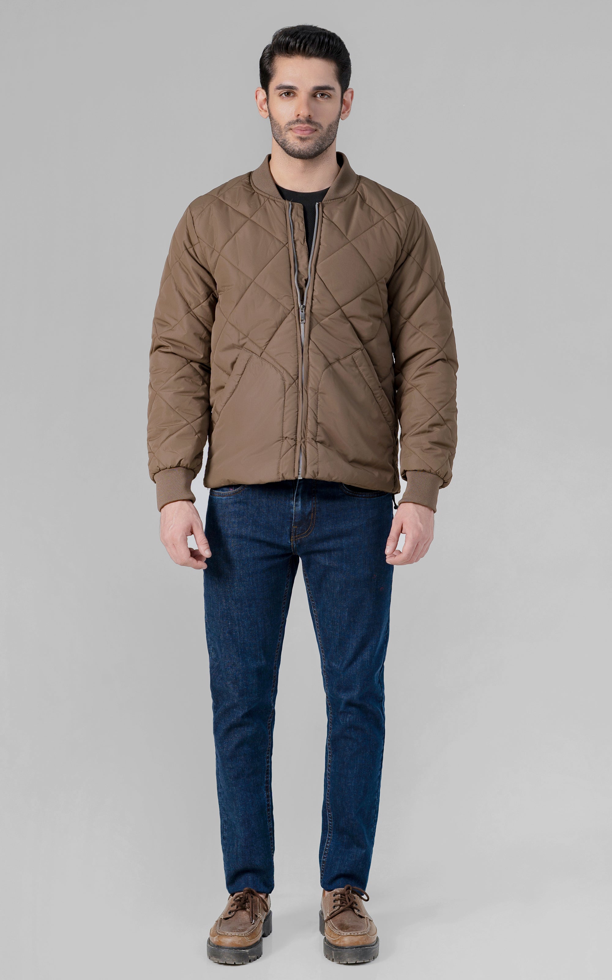 Quilted dark khaki bomber jacket with zip front, ribbed collar, and cuffs