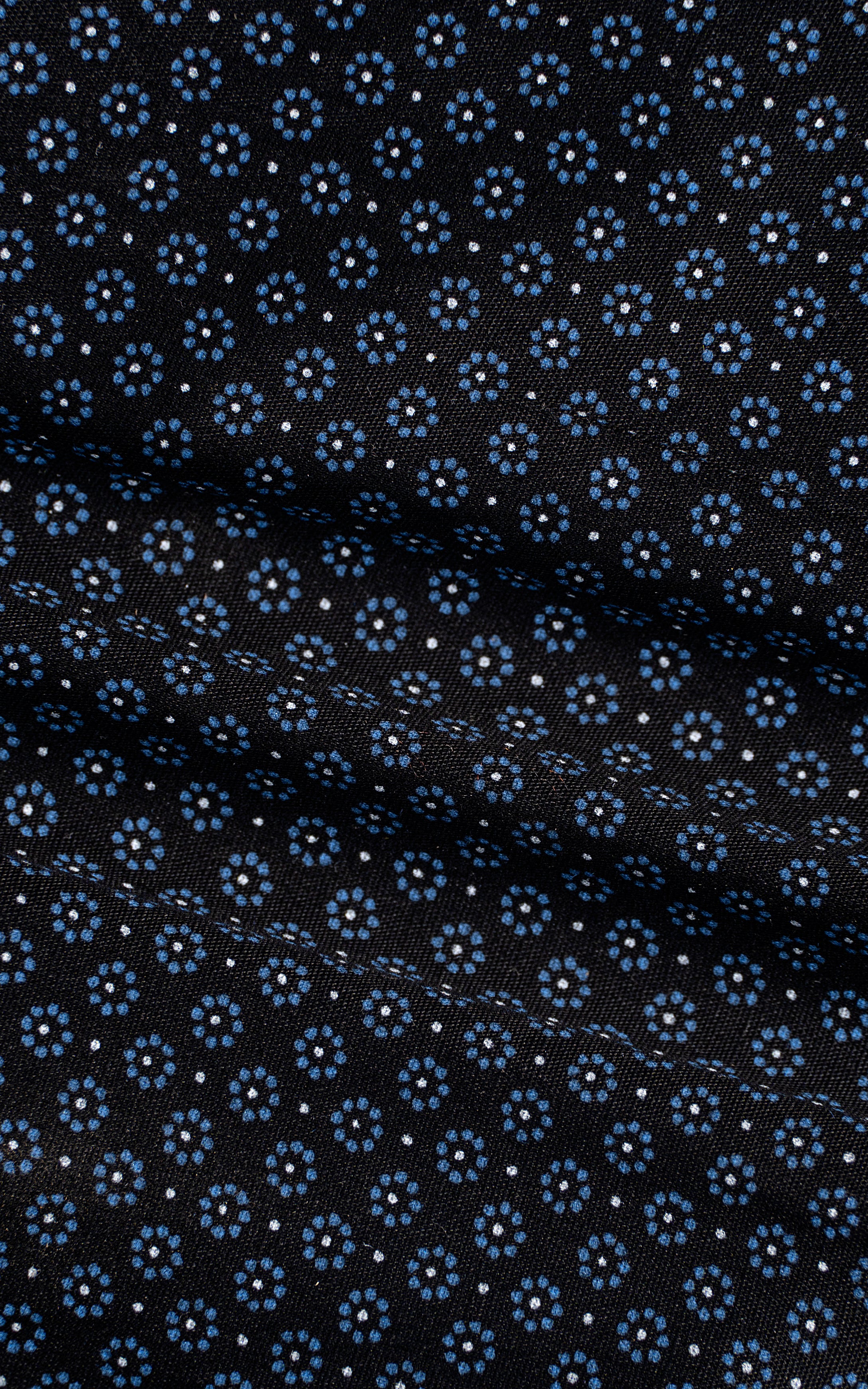 Men's dark dress shirt fabric close-up with small circular geometric pattern