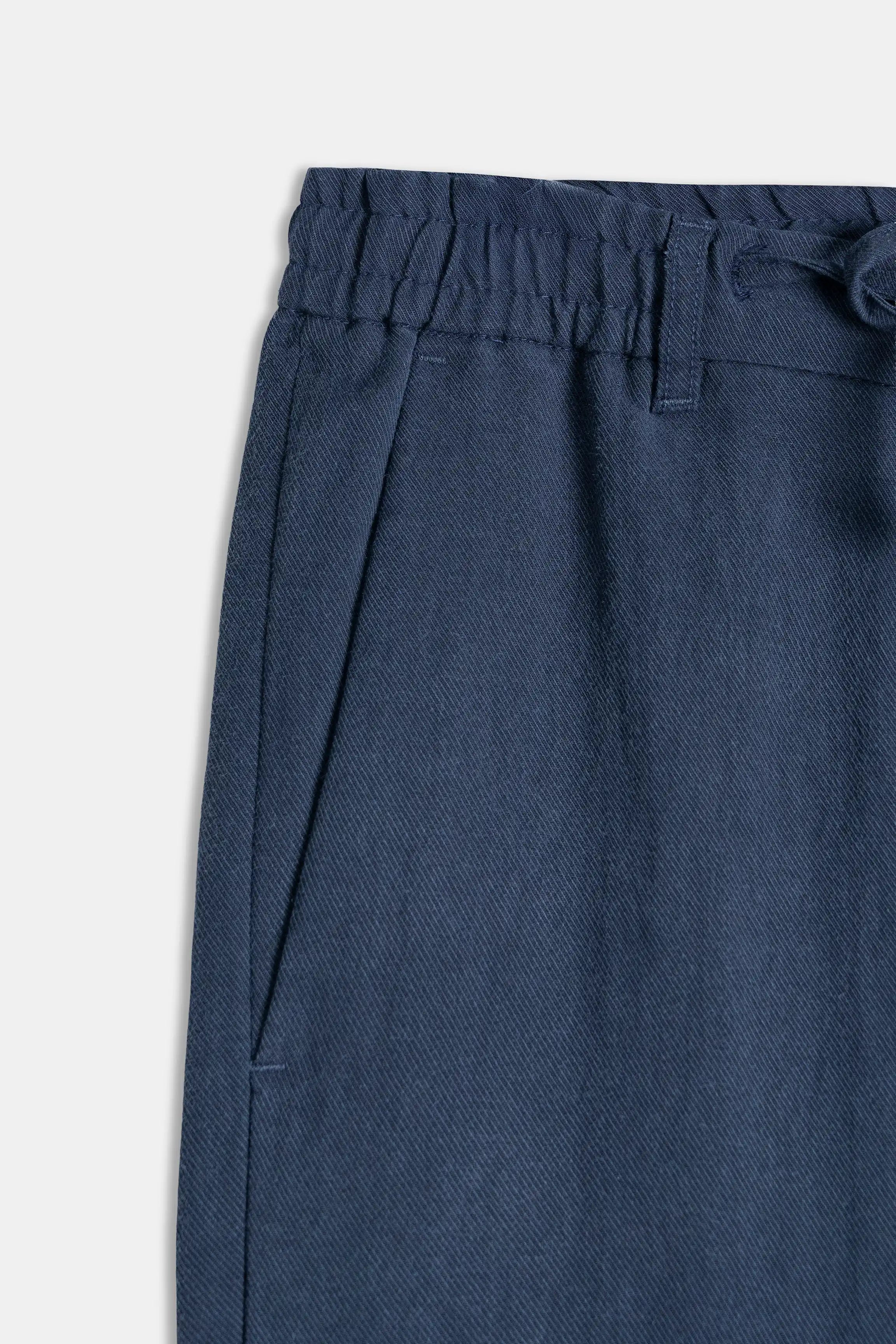 Navy pant waistband with elastic gathers and drawstring channel