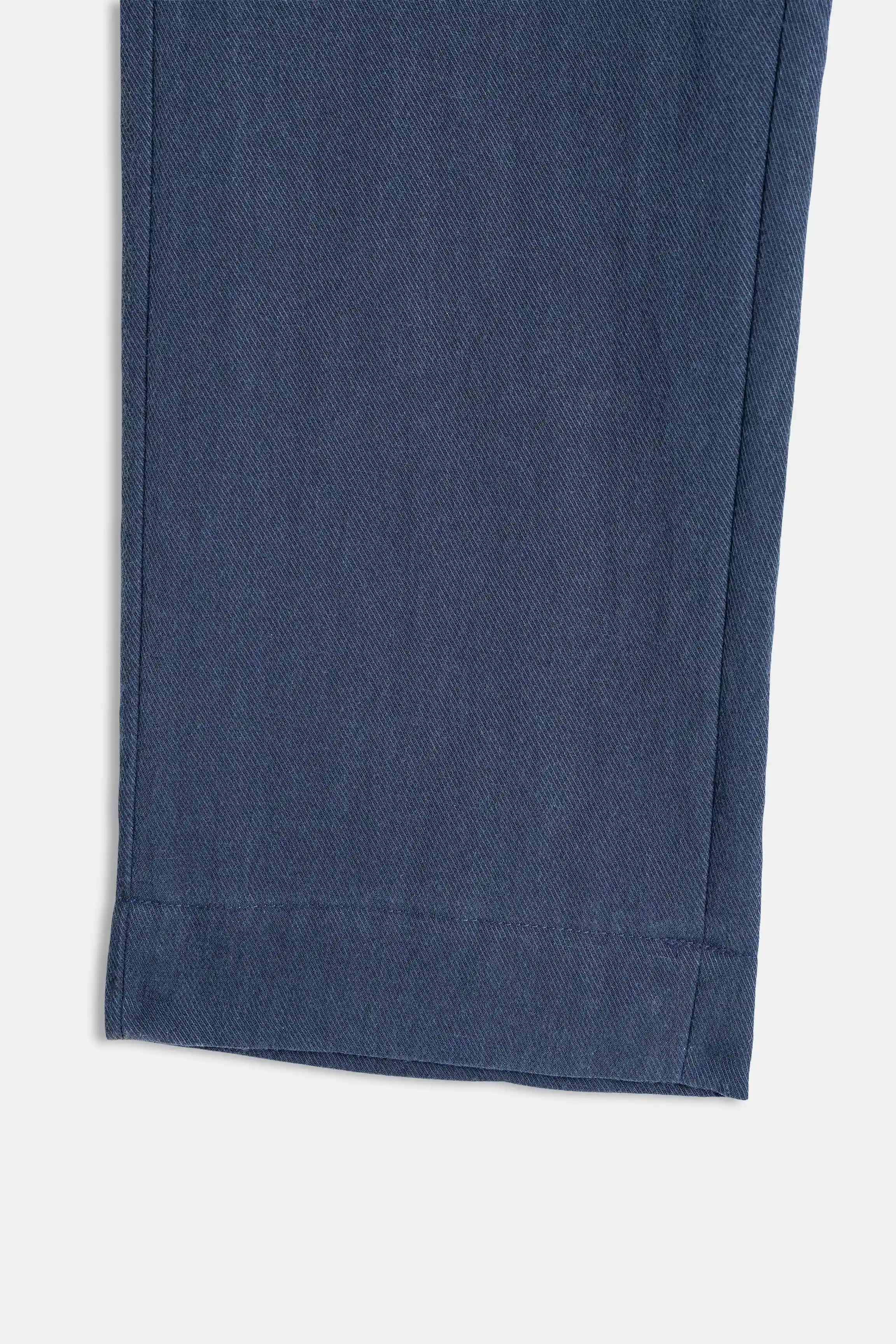 Navy straight-leg pant hem with simple stitched finish
