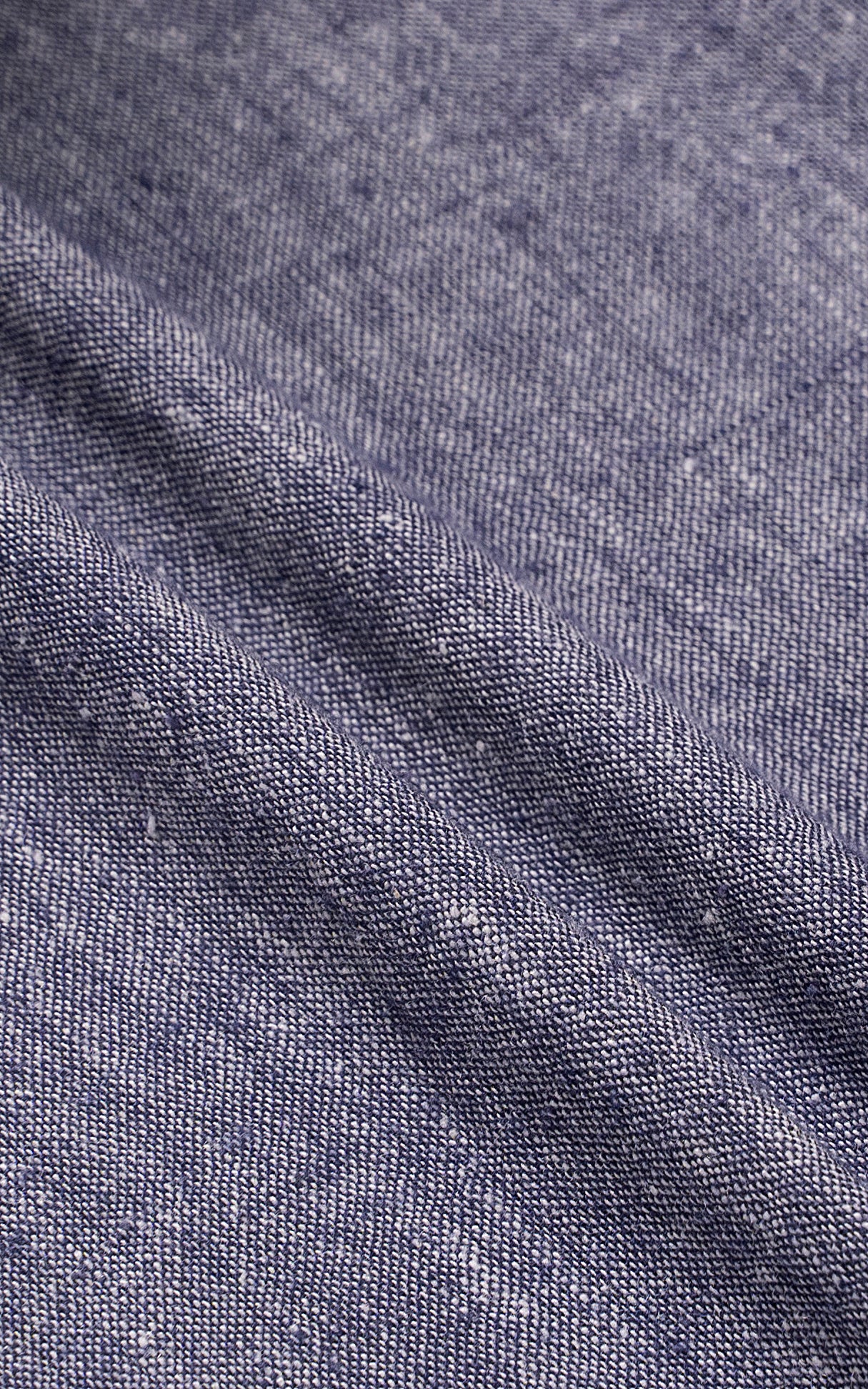 Linen shirt fabric close-up with textured weave and seam stitching