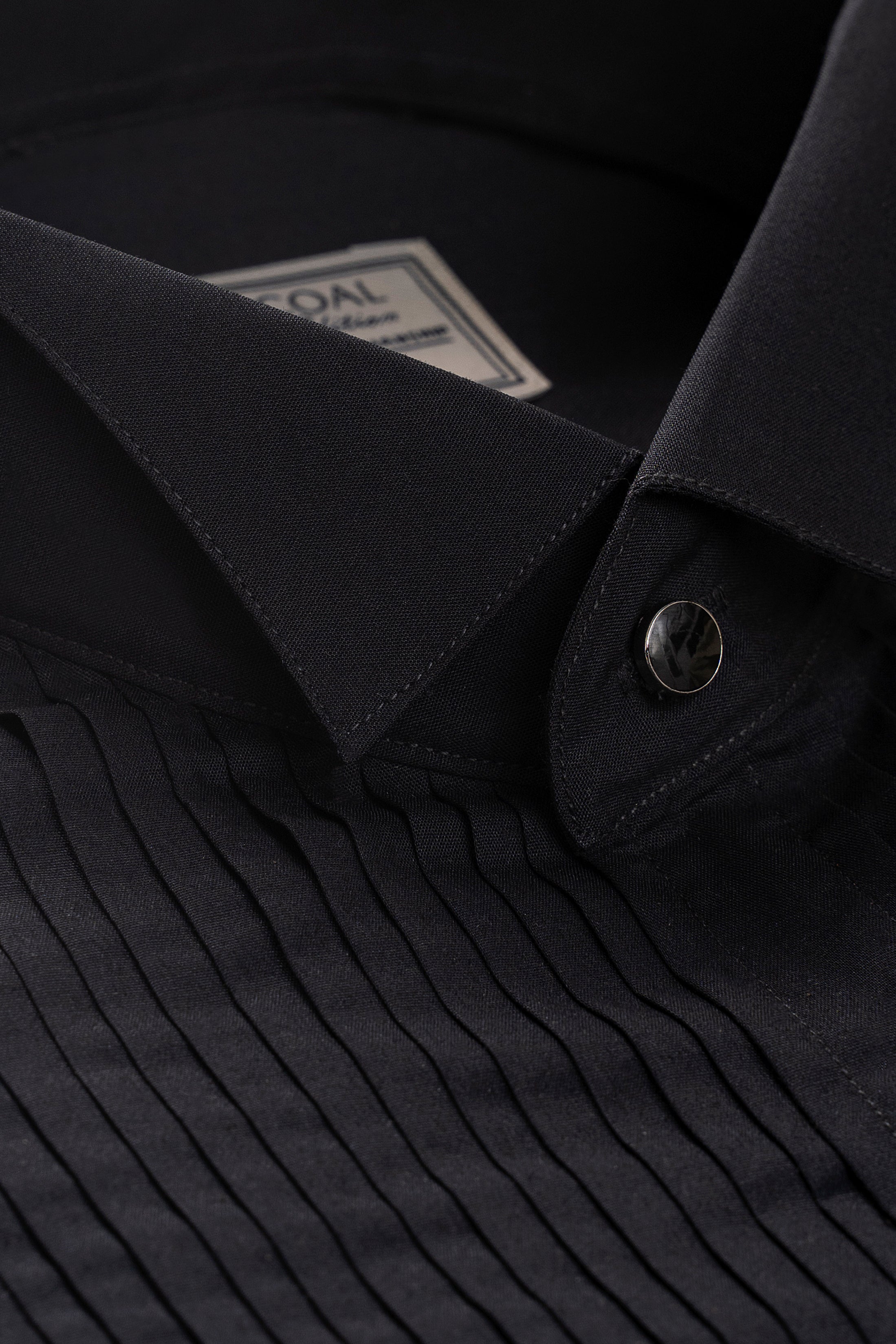 Dark dress shirt collar with button placket and round cuff buttons