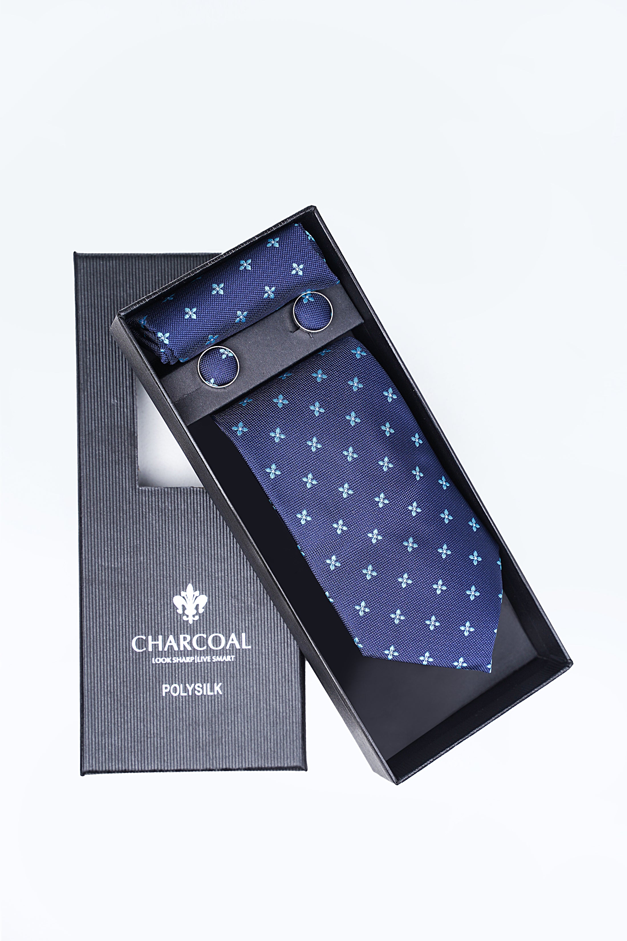 Tie set with navy patterned necktie, pocket square, and cufflinks in charcoal box