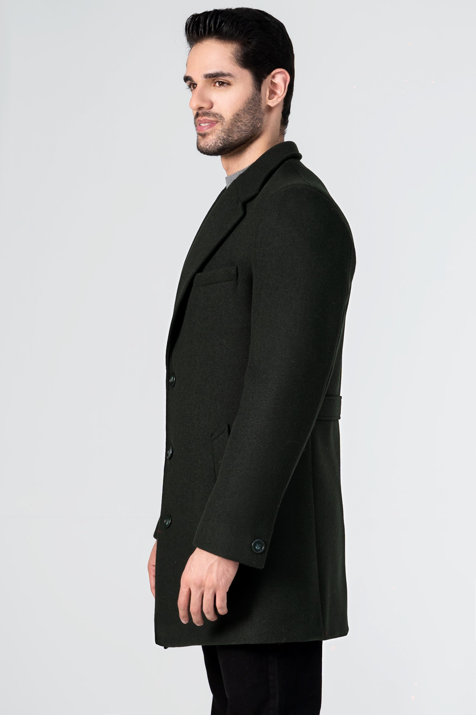 Dark green wool long coat, side view, with notched collar and buttoned cuffs