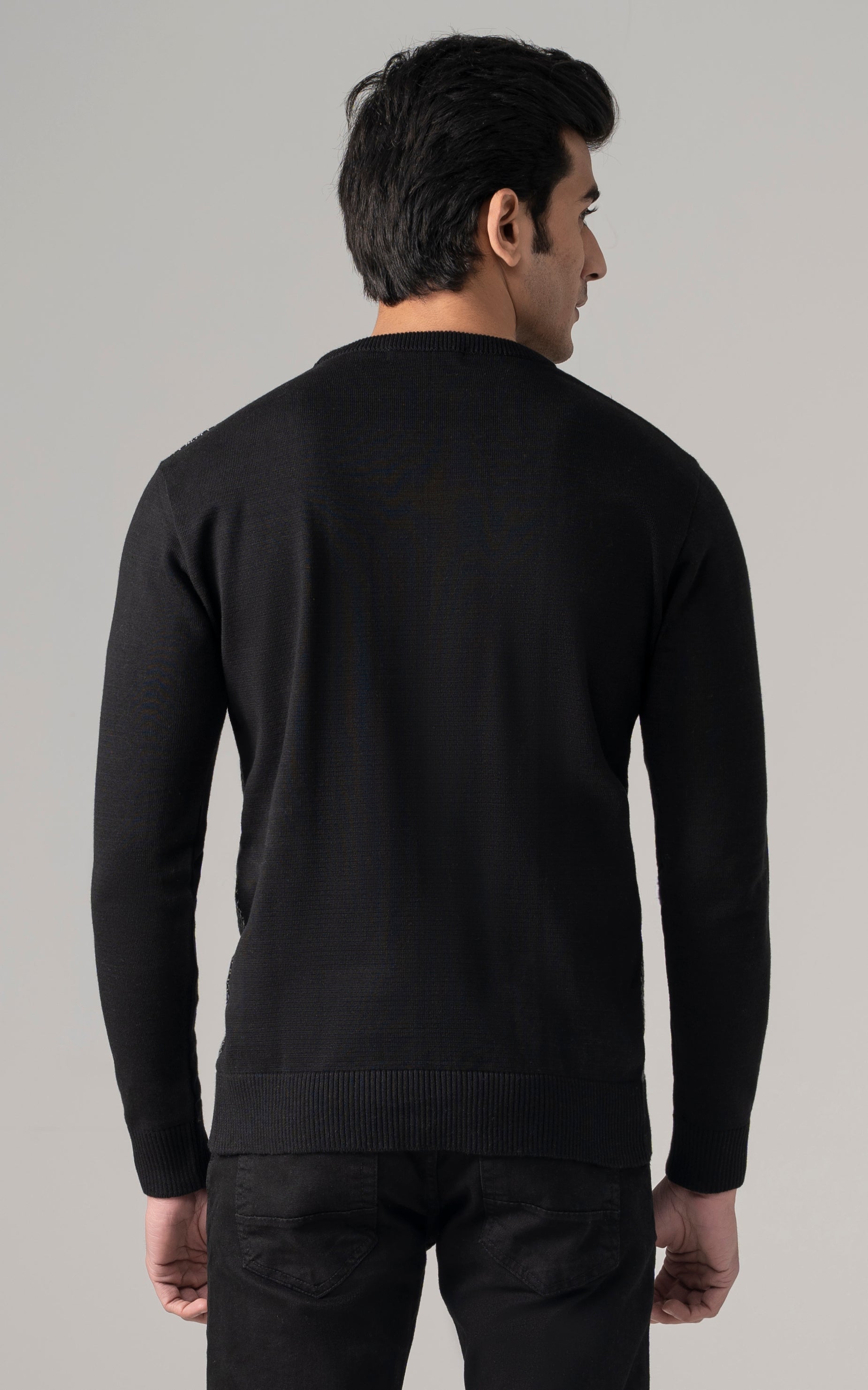 Textured crew neck sweater back view in dark black with ribbed cuffs
