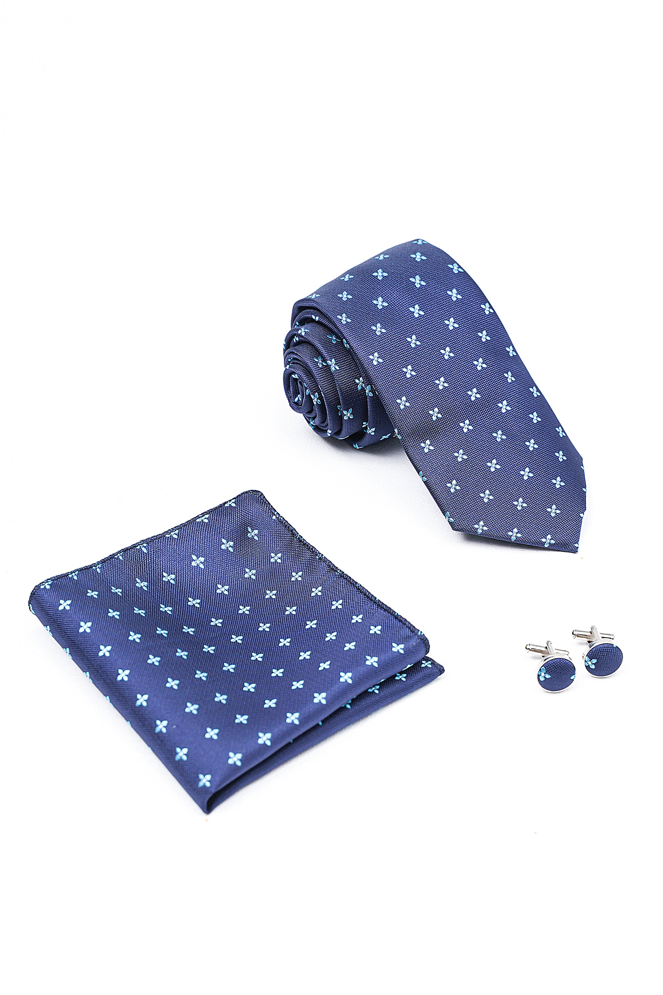 Navy patterned necktie, folded pocket square, and blue cufflinks
