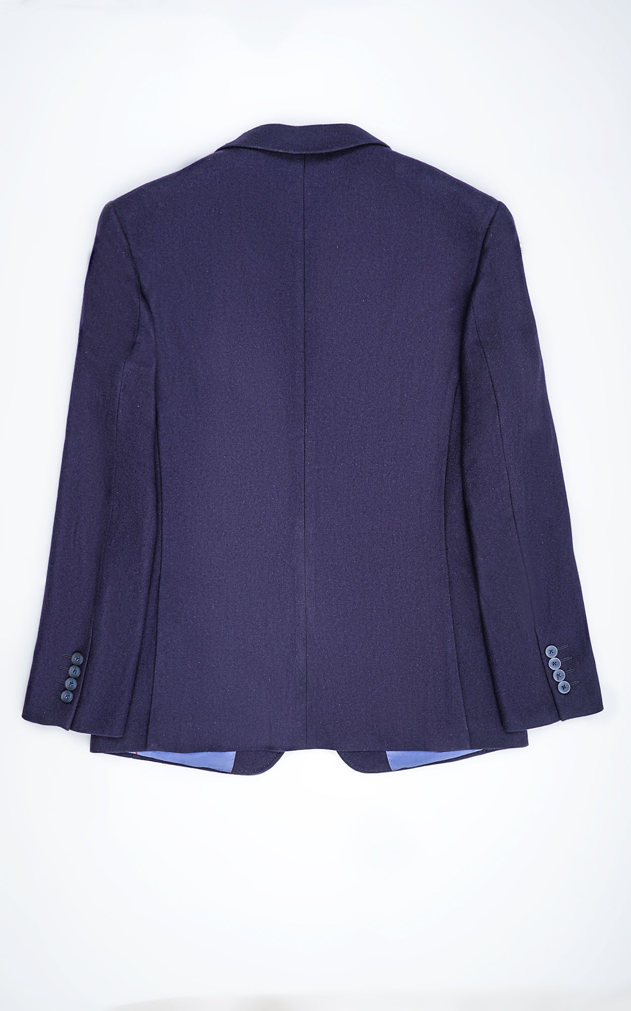 Back view of navy woolen coat with center seam and buttoned cuffs
