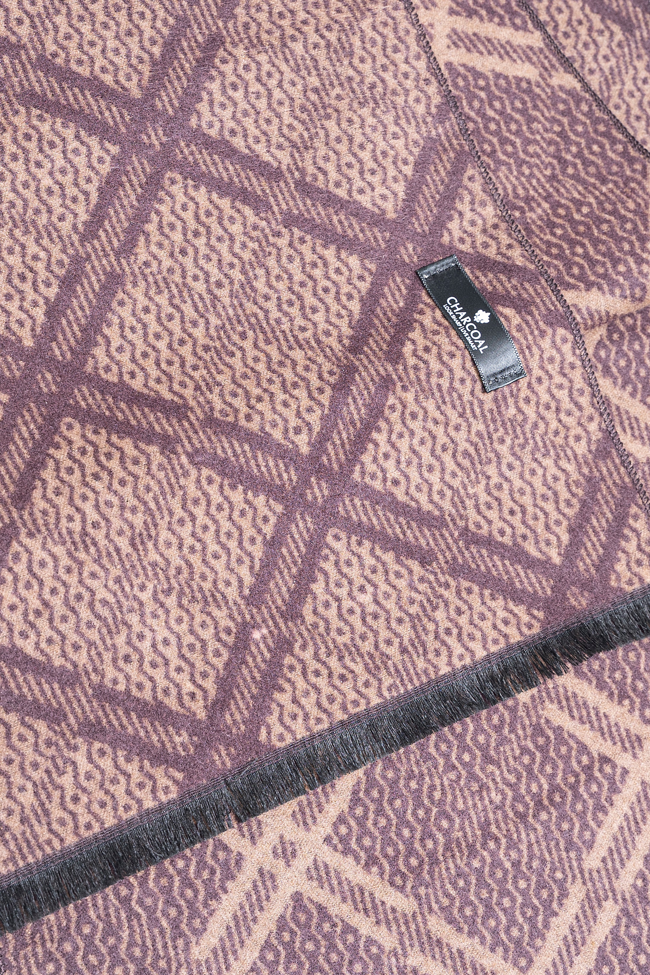 Purple scarf fabric close-up with textured pattern and beige plaid stripes