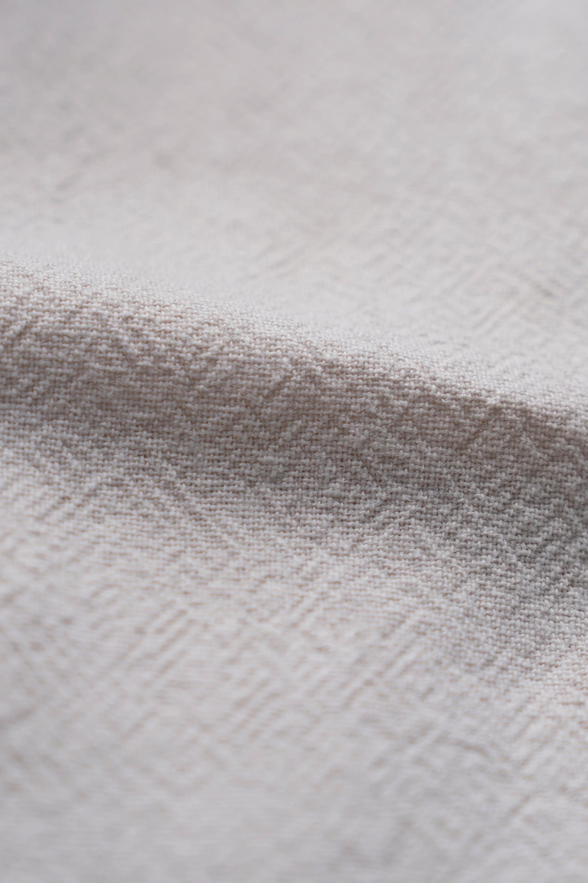 Beige textured shirt fabric close-up