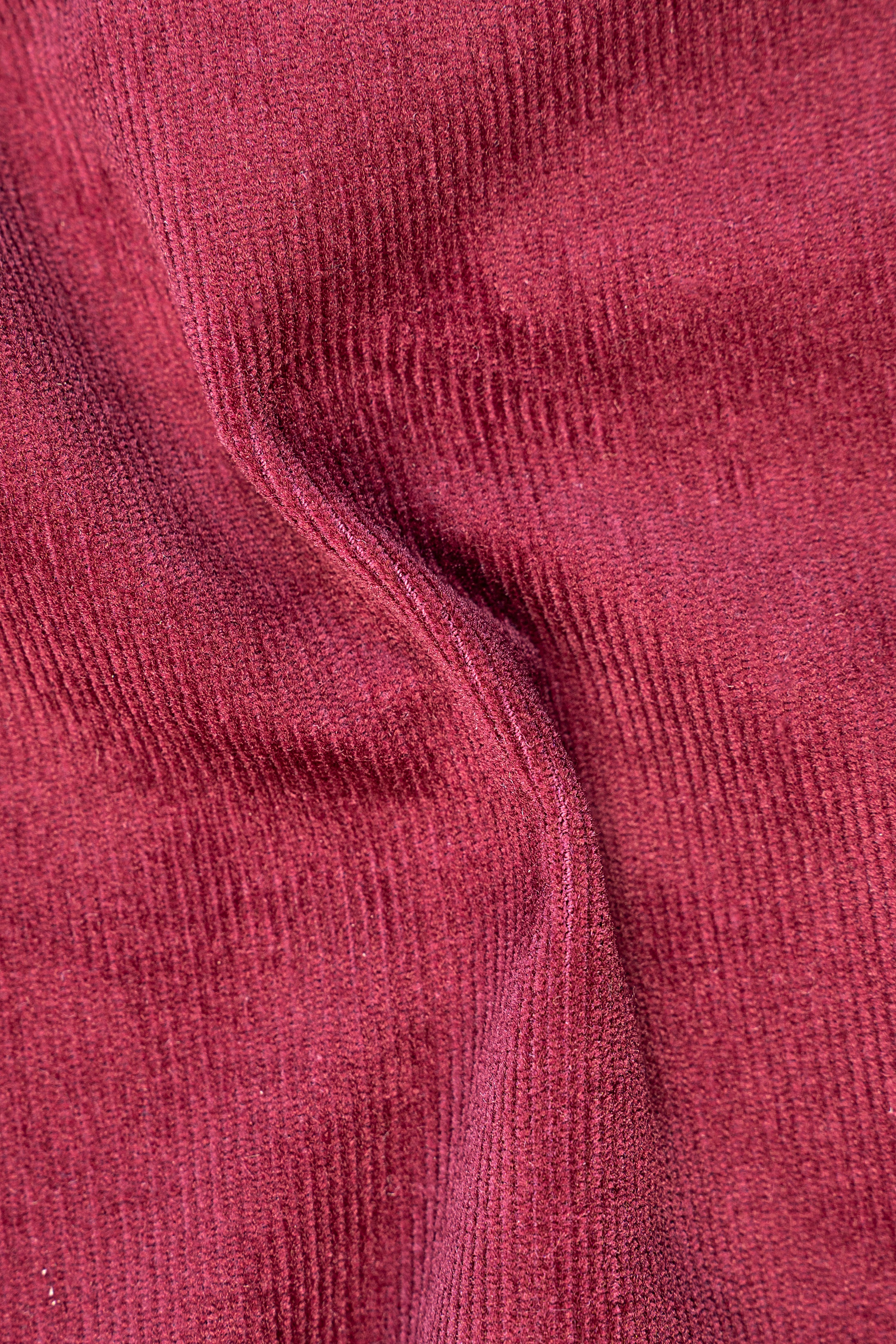 Wine red corduroy fabric texture close-up