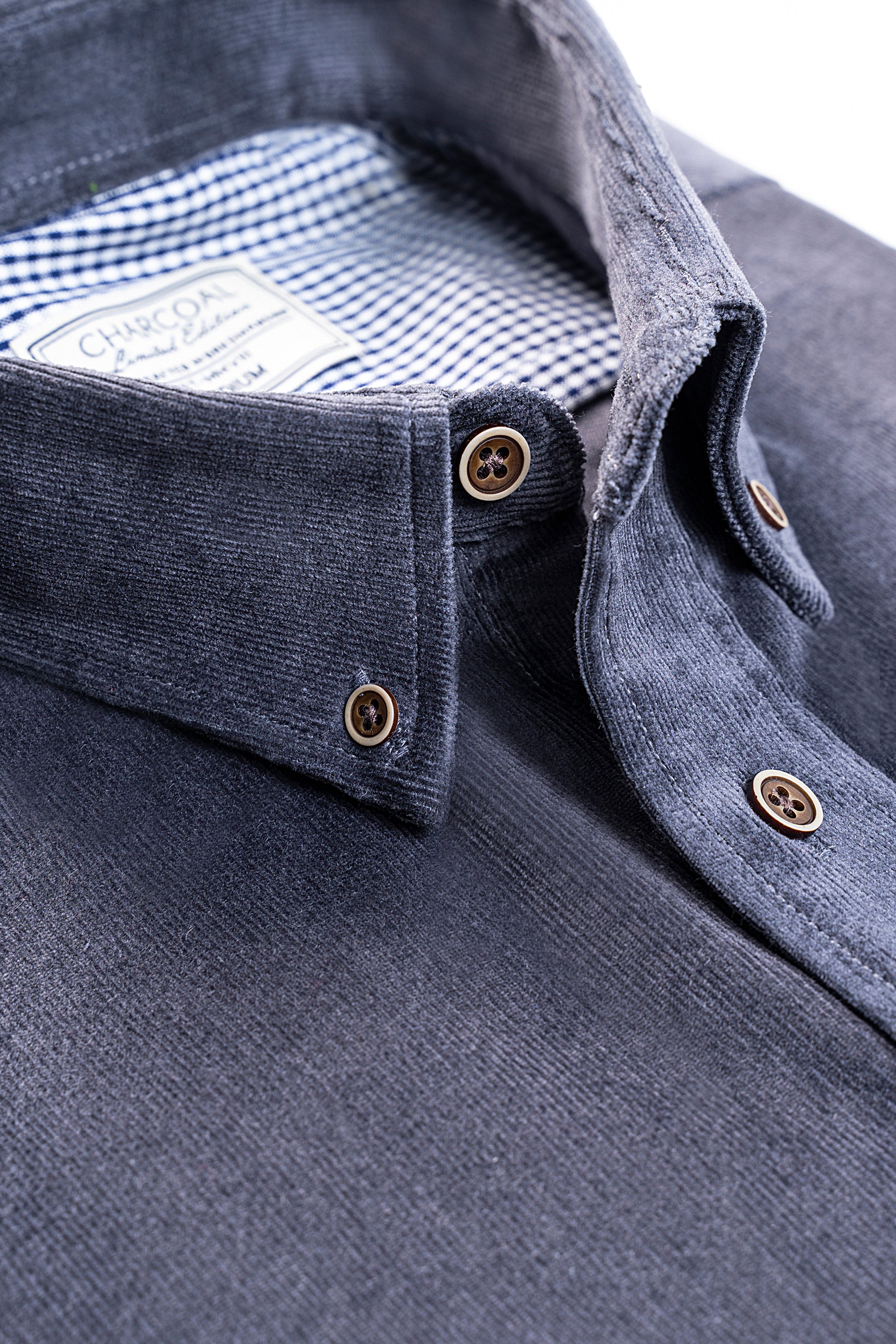 Grey corduroy shirt close-up: buttoned collar and check-lined inner placket
