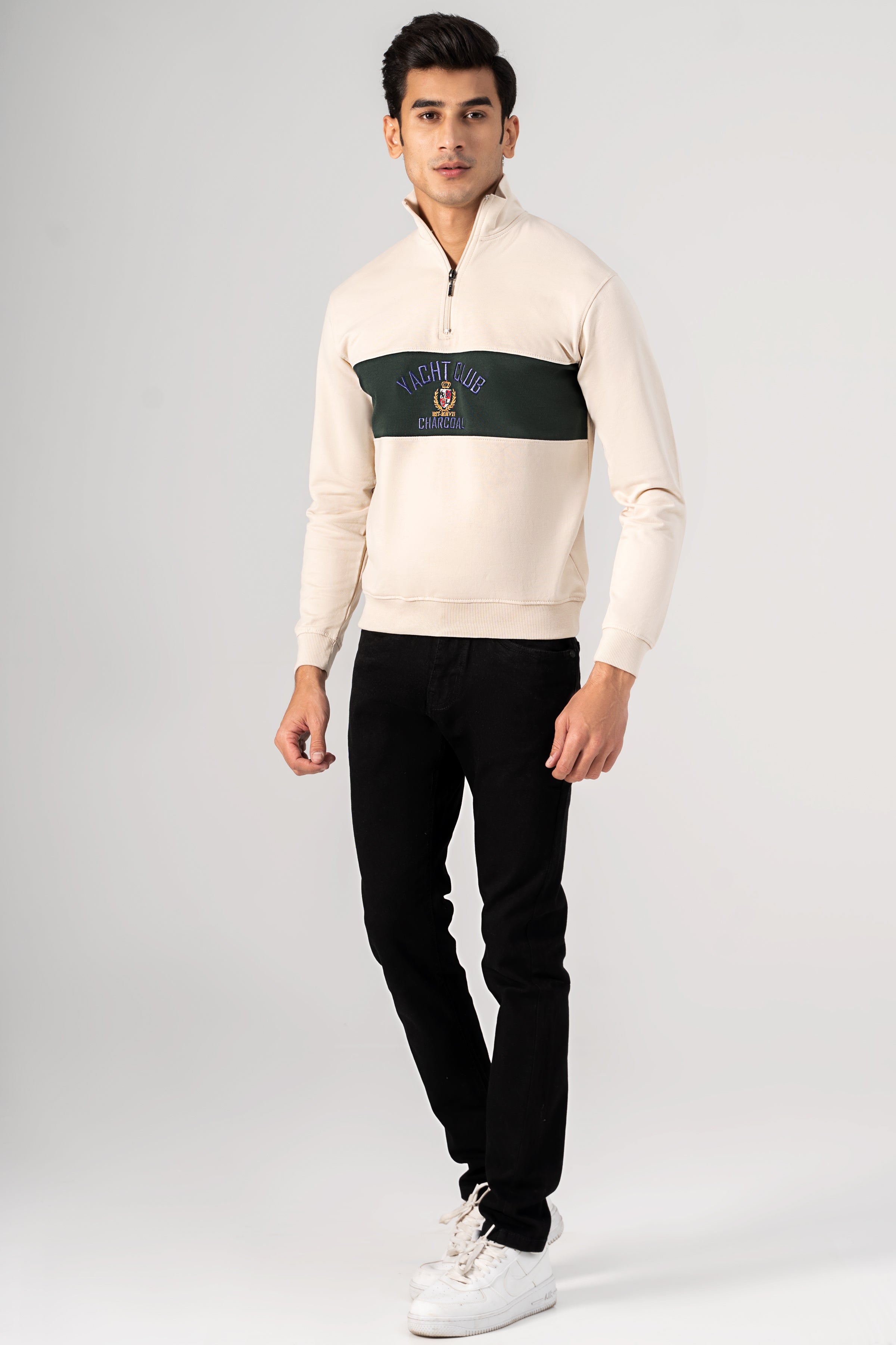 Beige mock neck quarter-zip sweatshirt with green chest panel and logo