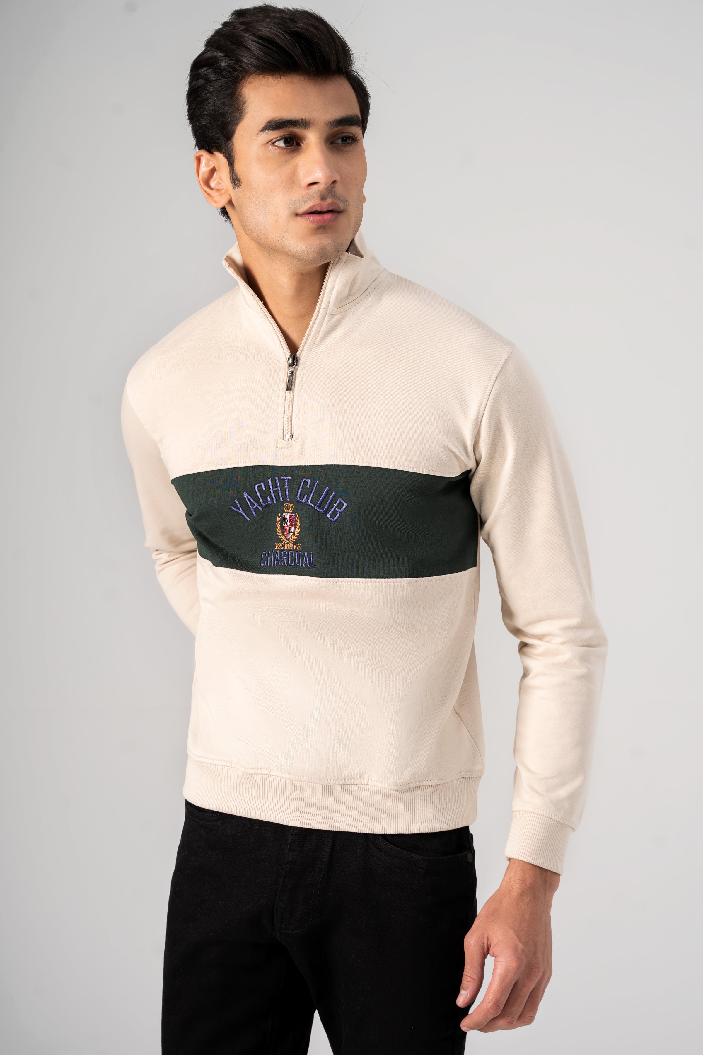 Beige mock neck quarter-zip sweatshirt with green chest band and crest