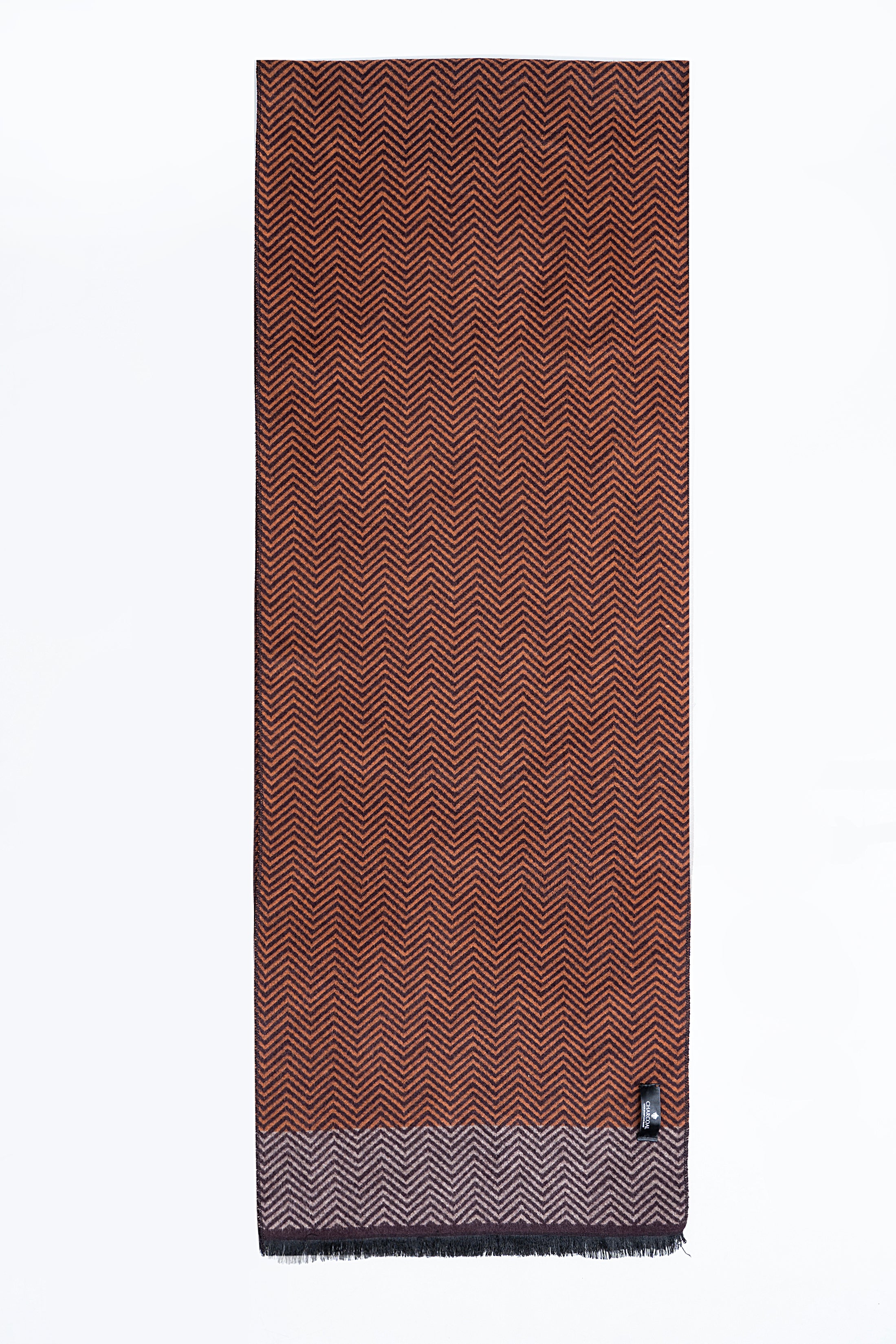 Chevron-pattern scarf in rust brown with dark zigzags and fringed edges