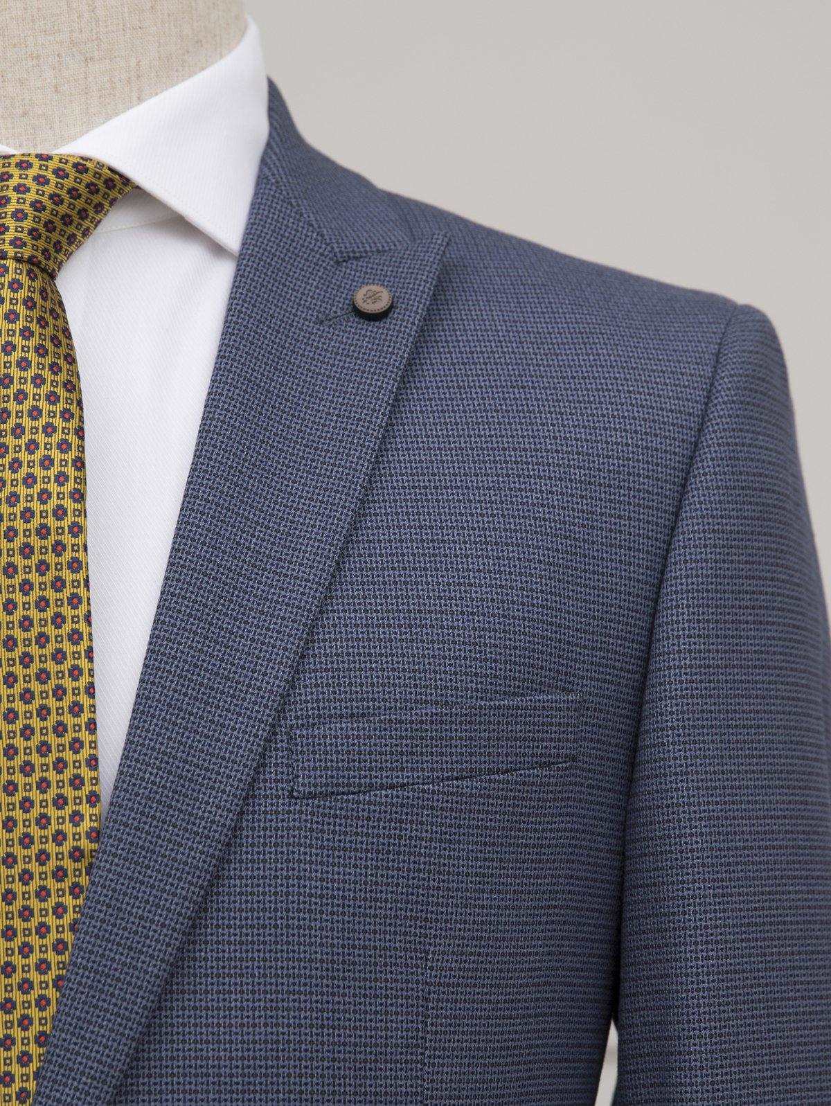 Blue textured suit jacket with notch lapel, single button, and white dress shirt collar