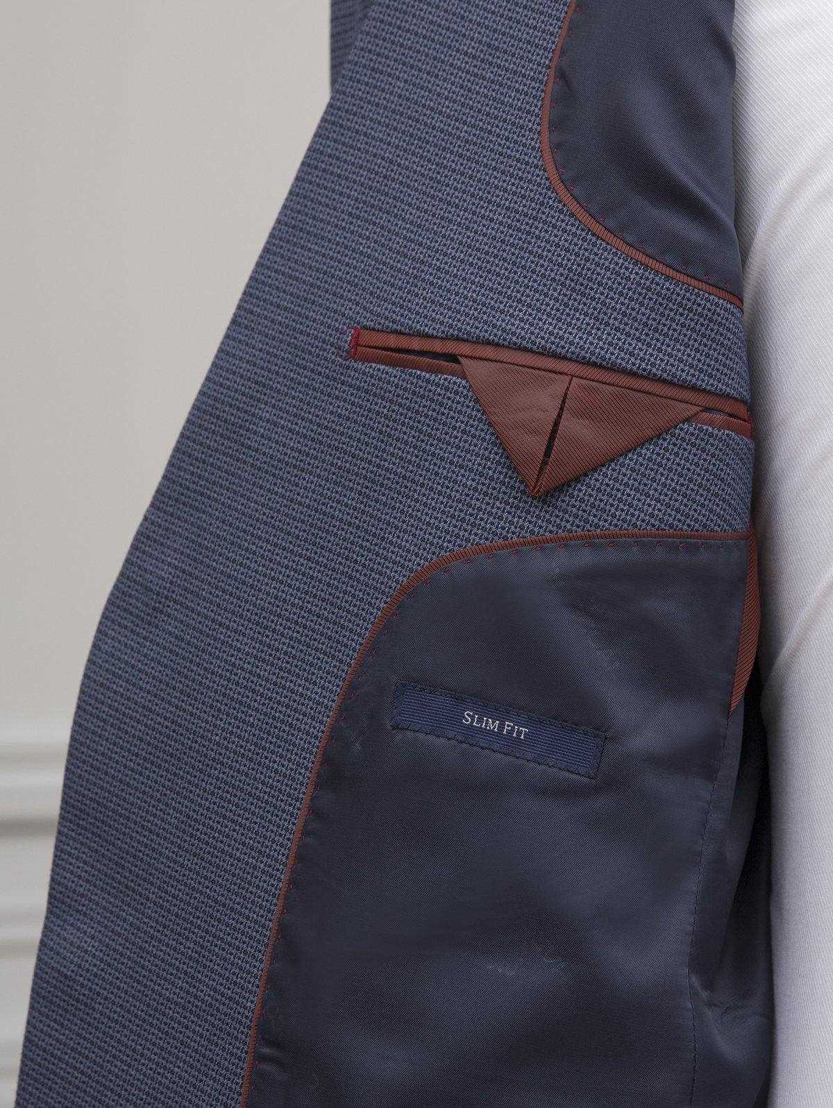 Blue suit jacket with slim-fit label inside pocket and dark interior lining