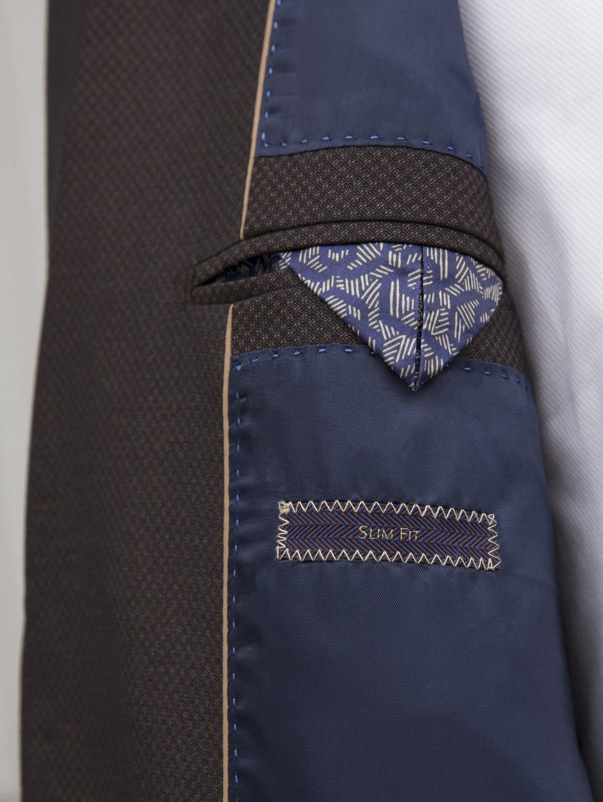 Brown suit trouser detail with blue lining and patterned pocket panel