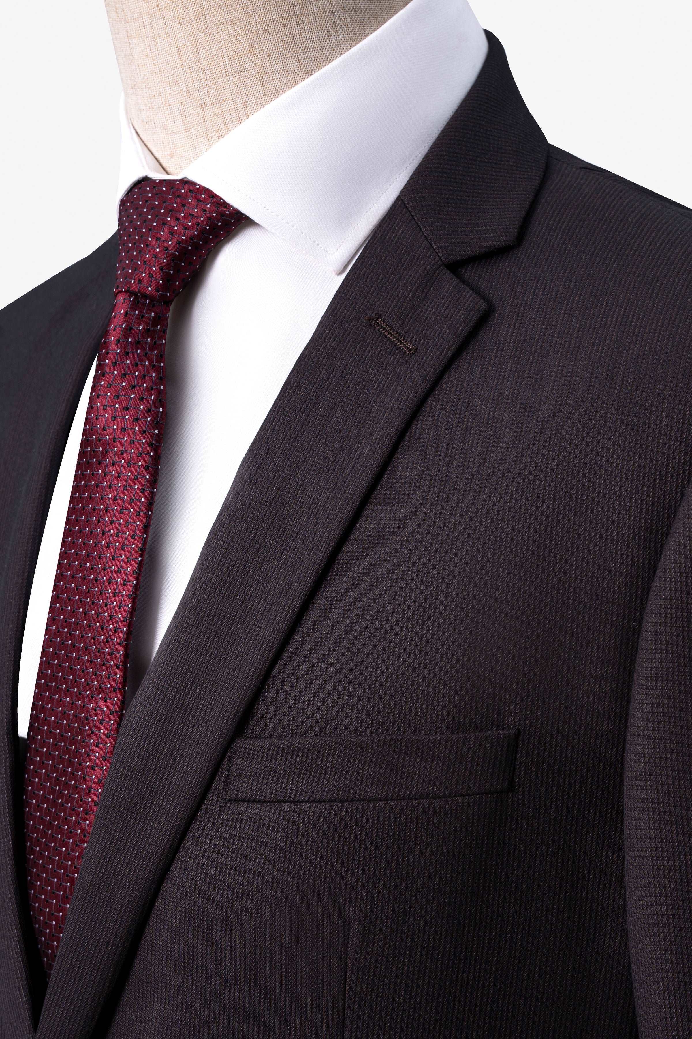 Brown suit jacket lapel with matching pocket and textured fabric