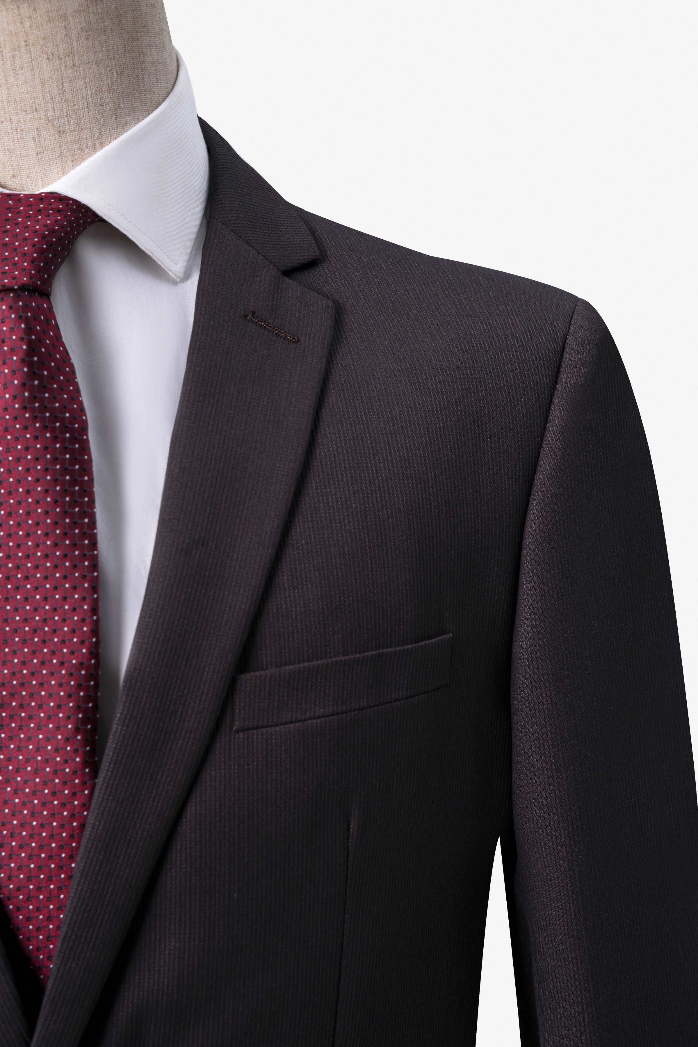 Brown suit jacket shoulder and chest pocket detail, with textured weave