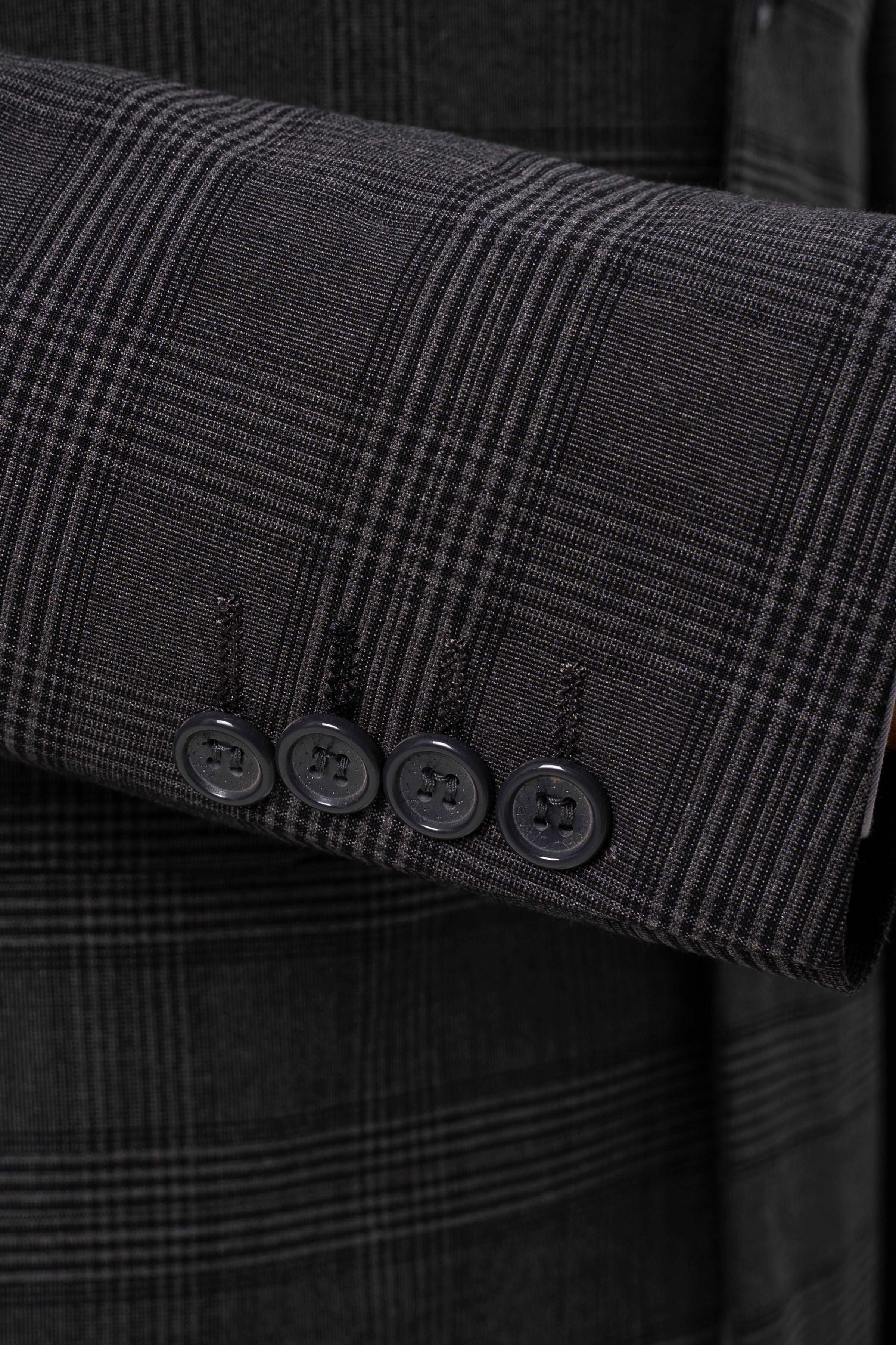 Dark grey suit jacket cuff with four-button detail