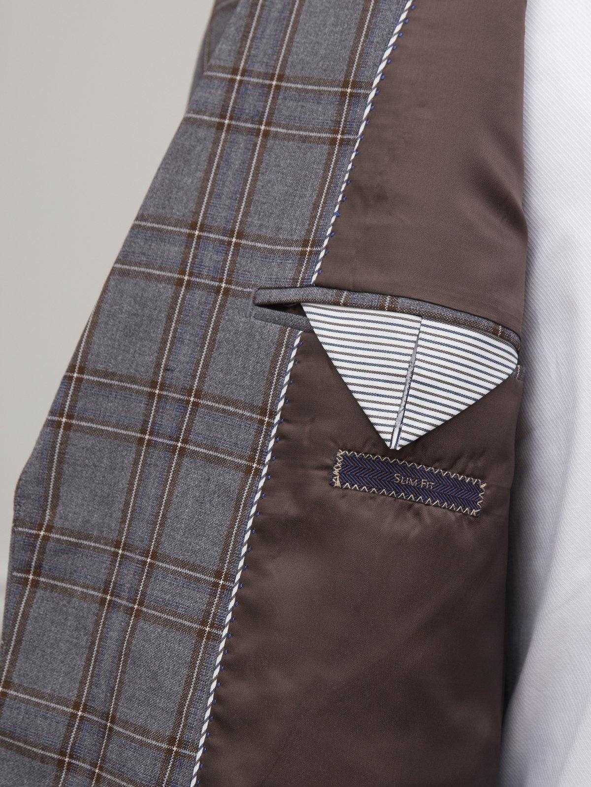 Grey plaid suit vest pocket with striped trim and pocket square