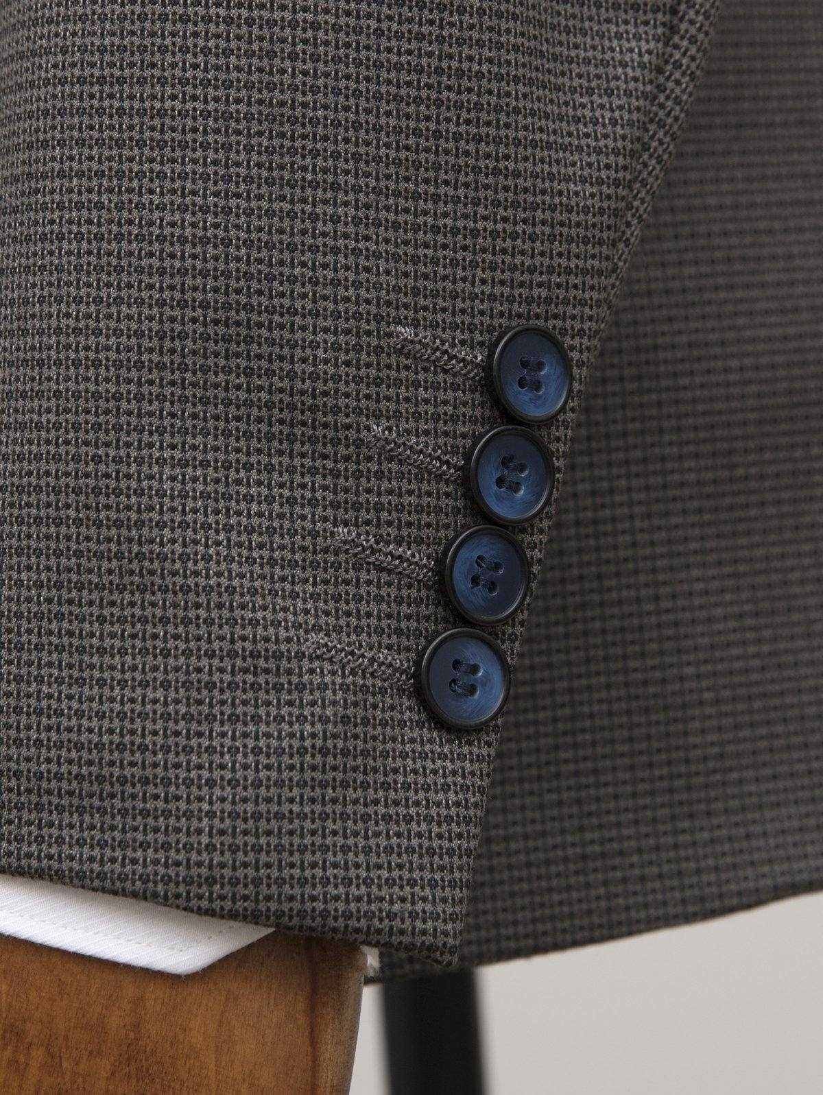 Grey suit jacket front with three blue buttons