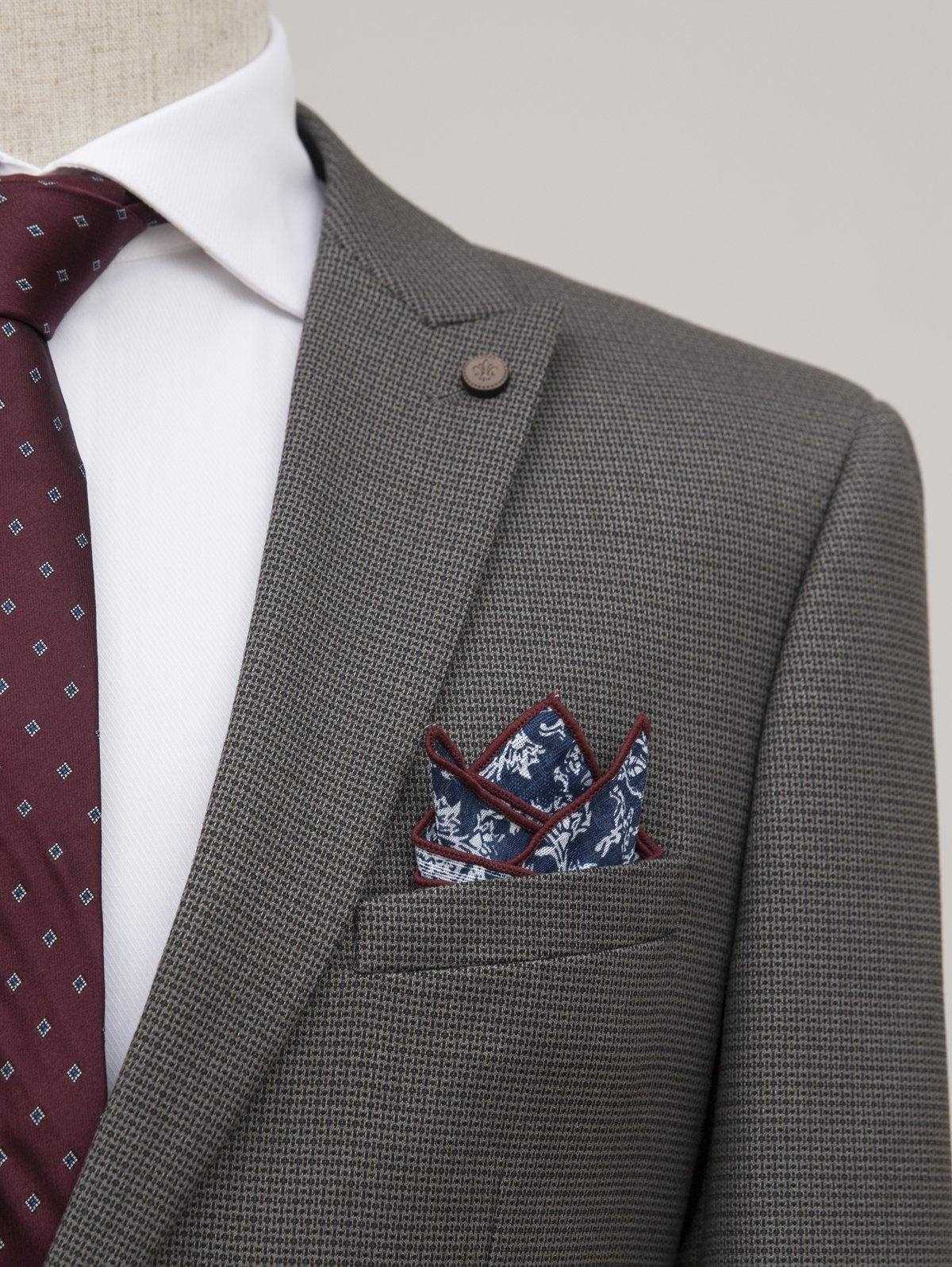 Grey suit jacket lapel with breast pocket and patterned pocket square