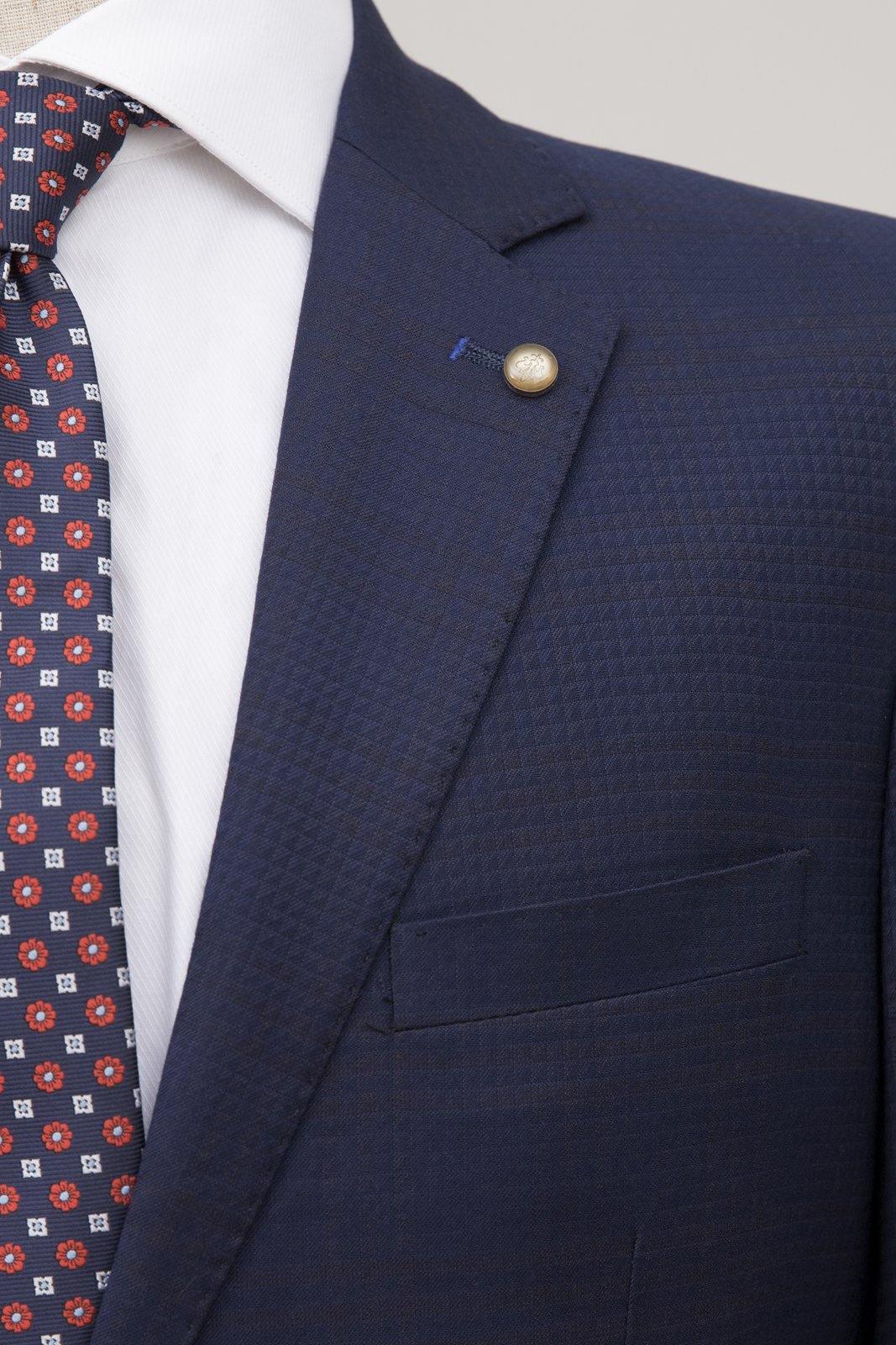 Navy blue suit blazer lapel with patterned texture and breast pocket