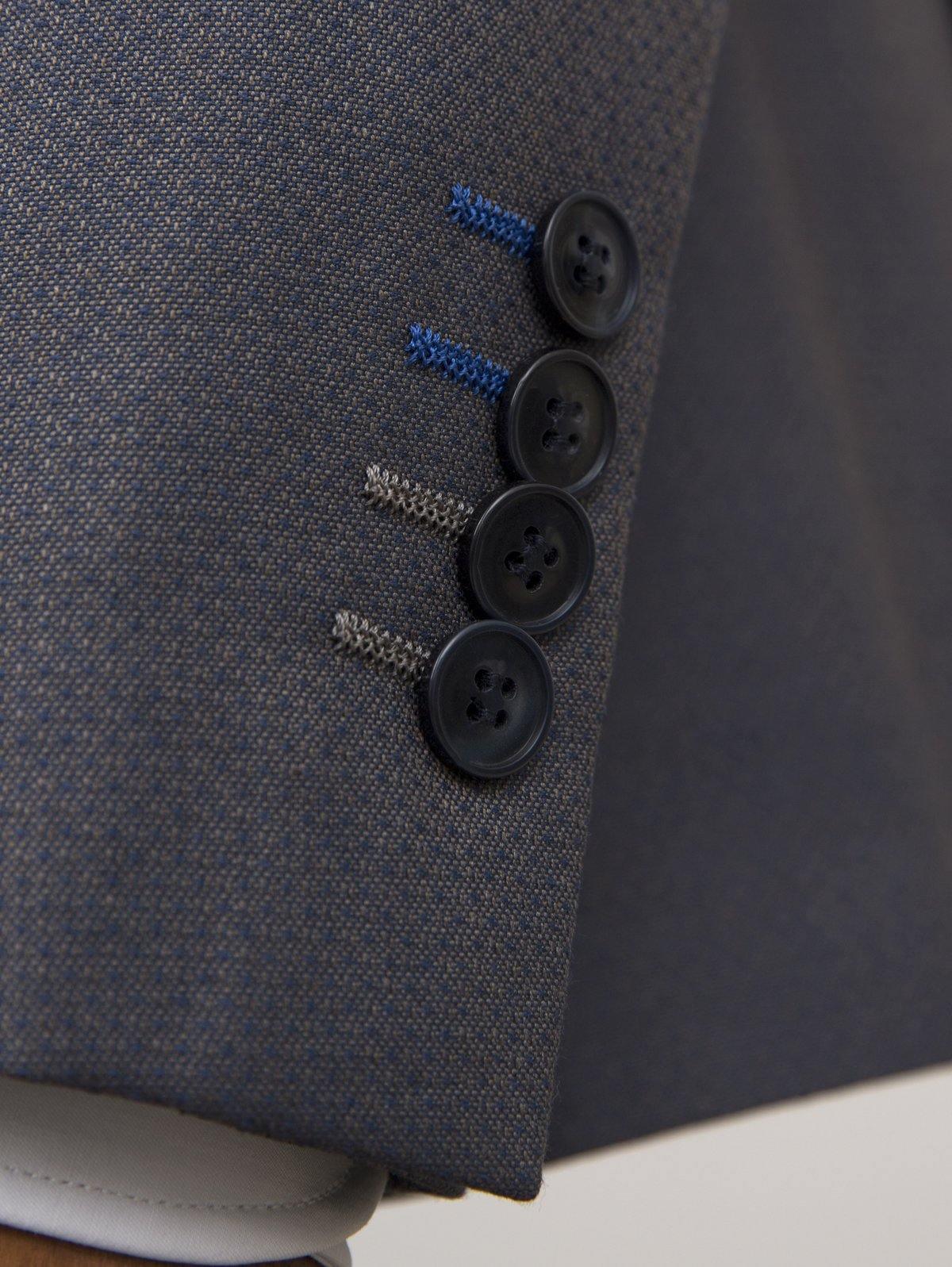 Dark navy suit blazer front with four buttonholes and textured fabric