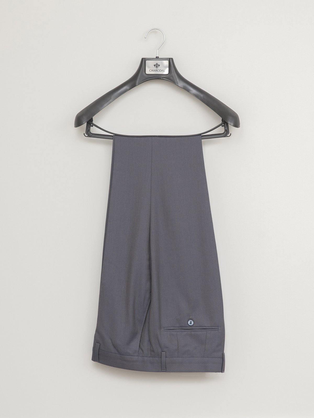 Navy straight-leg suit trousers hanging with waistband and side pocket